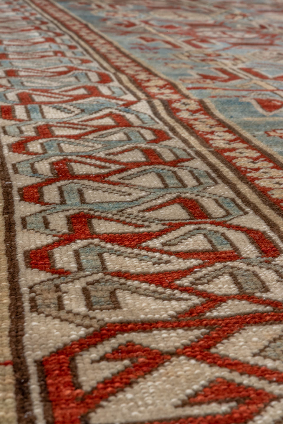 5' x 9' one-of-a-kind handmade antique Caucasian medium size rug. Color palette: light blue, ivory, rust, red, slate, camel