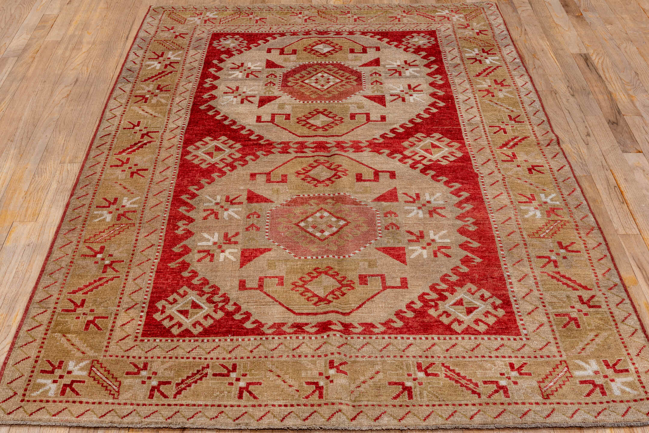 4' x 7' one-of-a-kind handmade antique Caucasian rug. Color palette: rust, ivory, camel, rose, terra cotta, terracotta