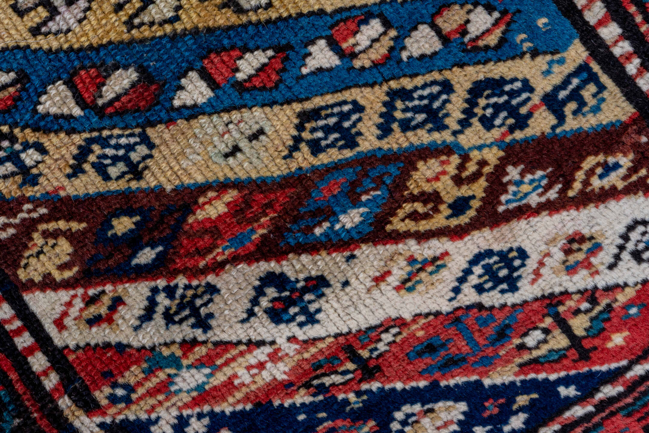 2' x 5' one-of-a-kind handmade antique Caucasian small size rug. Color palette: ivory, navy, rust, sky blue, brown, red