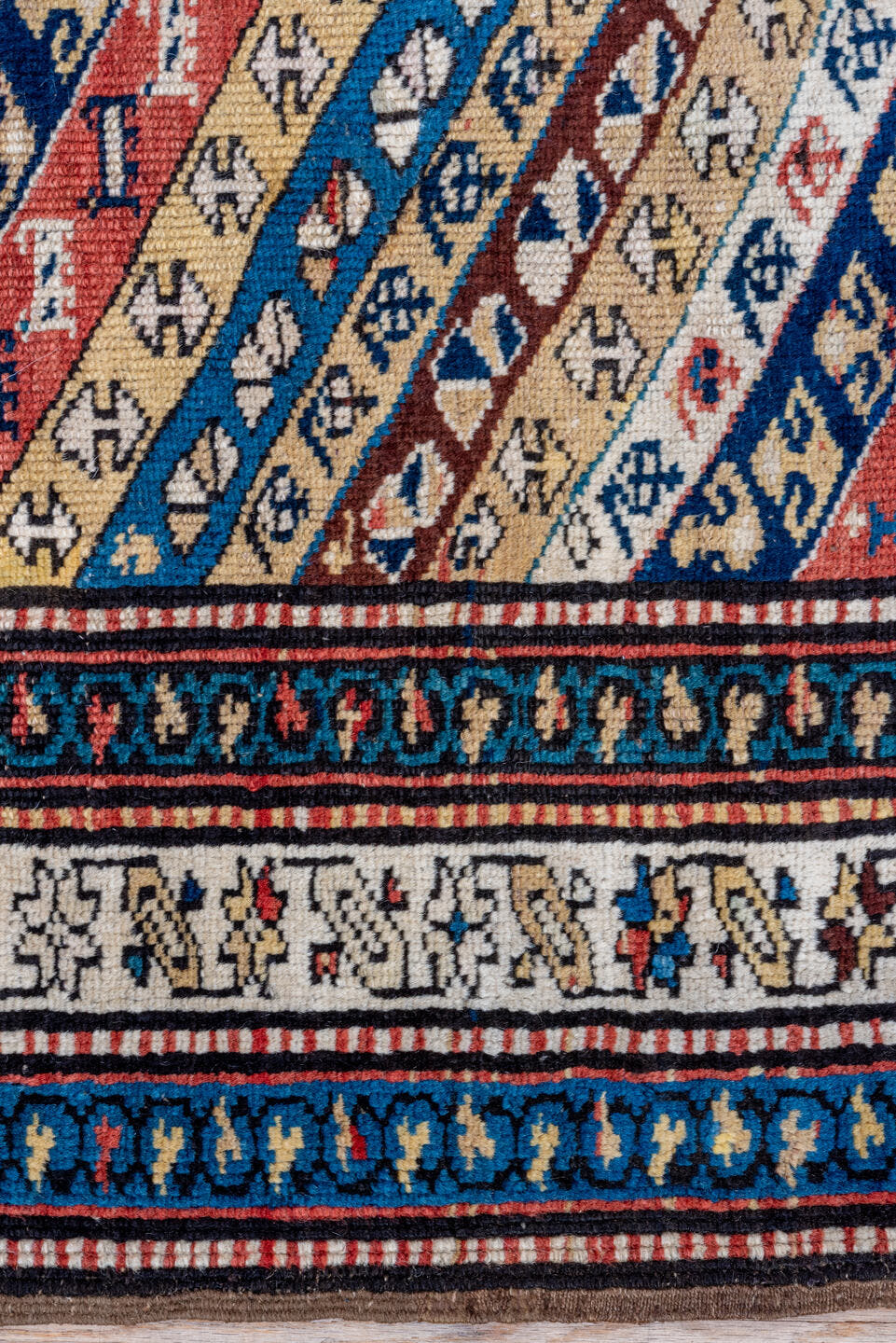 2' x 5' one-of-a-kind handmade antique Caucasian small size rug. Color palette: ivory, navy, rust, sky blue, brown, red