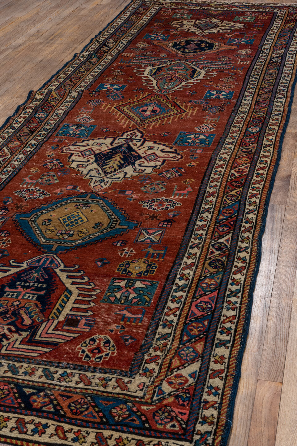 3' x 13' one-of-a-kind handmade antique NW Persian runner rug. Color palette: rust, ivory, indigo, sky blue, camel, crimson
