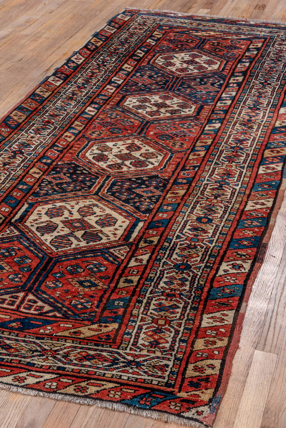 3' x 9' one-of-a-kind handmade antique NW Persian runner rug. Color palette: rust, indigo, ivory, navy, terra cotta, camel