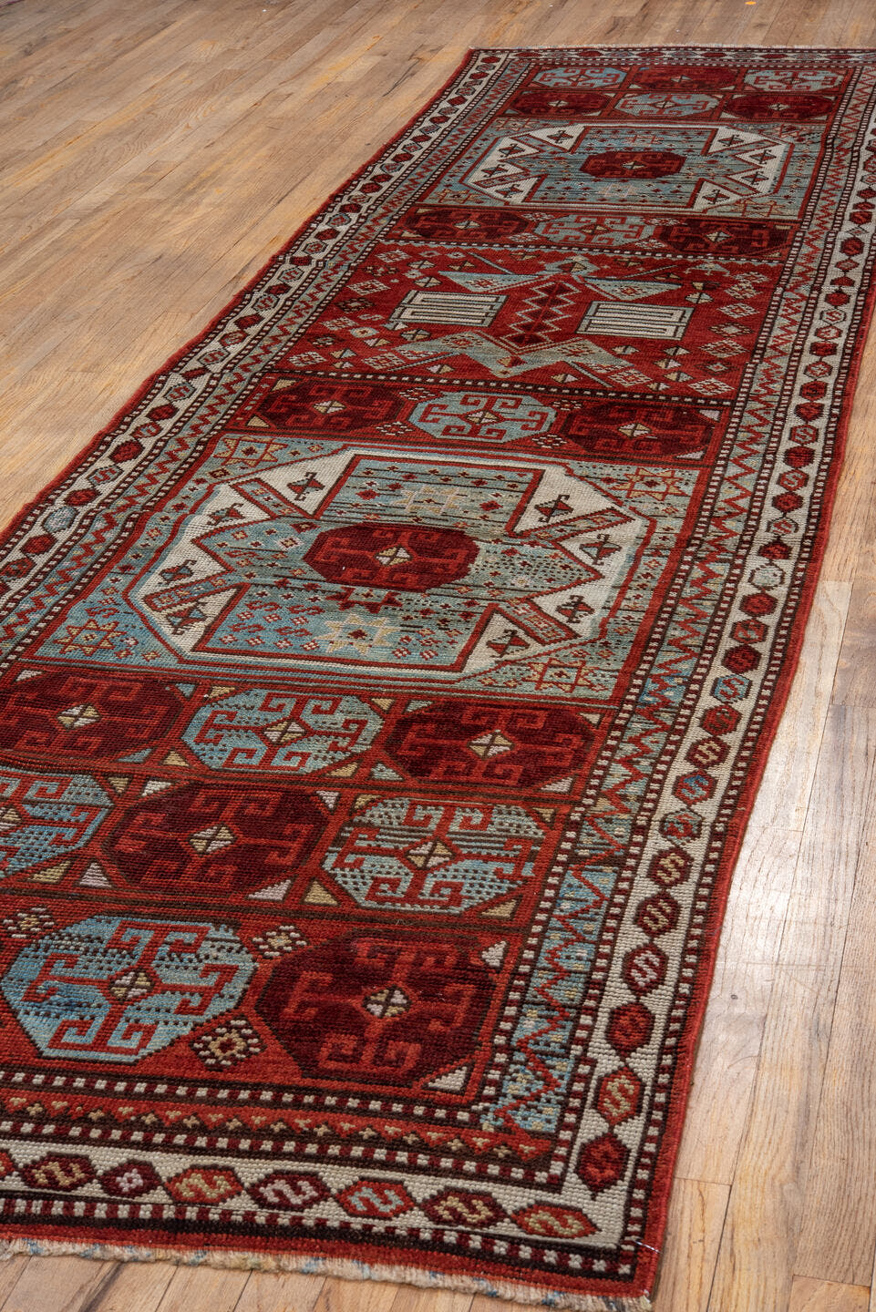 3' x 13' one-of-a-kind handmade antique Anatolian runner rug. Color palette: rust, pale blue, ivory, brick, brown, charcoal