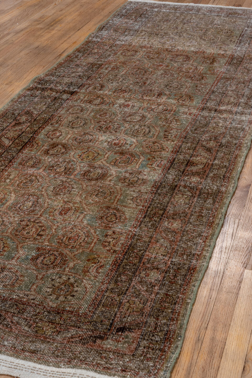 3' x 11' one-of-a-kind handmade antique Sarab runner rug. Color palette: taupe, terra cotta, brown, faded blue, rust, ivory
