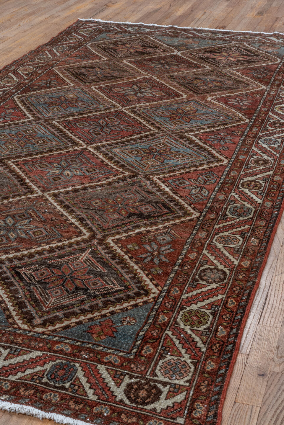 5' x 10' one-of-a-kind handmade antique Baktiary medium size rug. Color palette: rust, ivory, sky blue, brown, burgundy