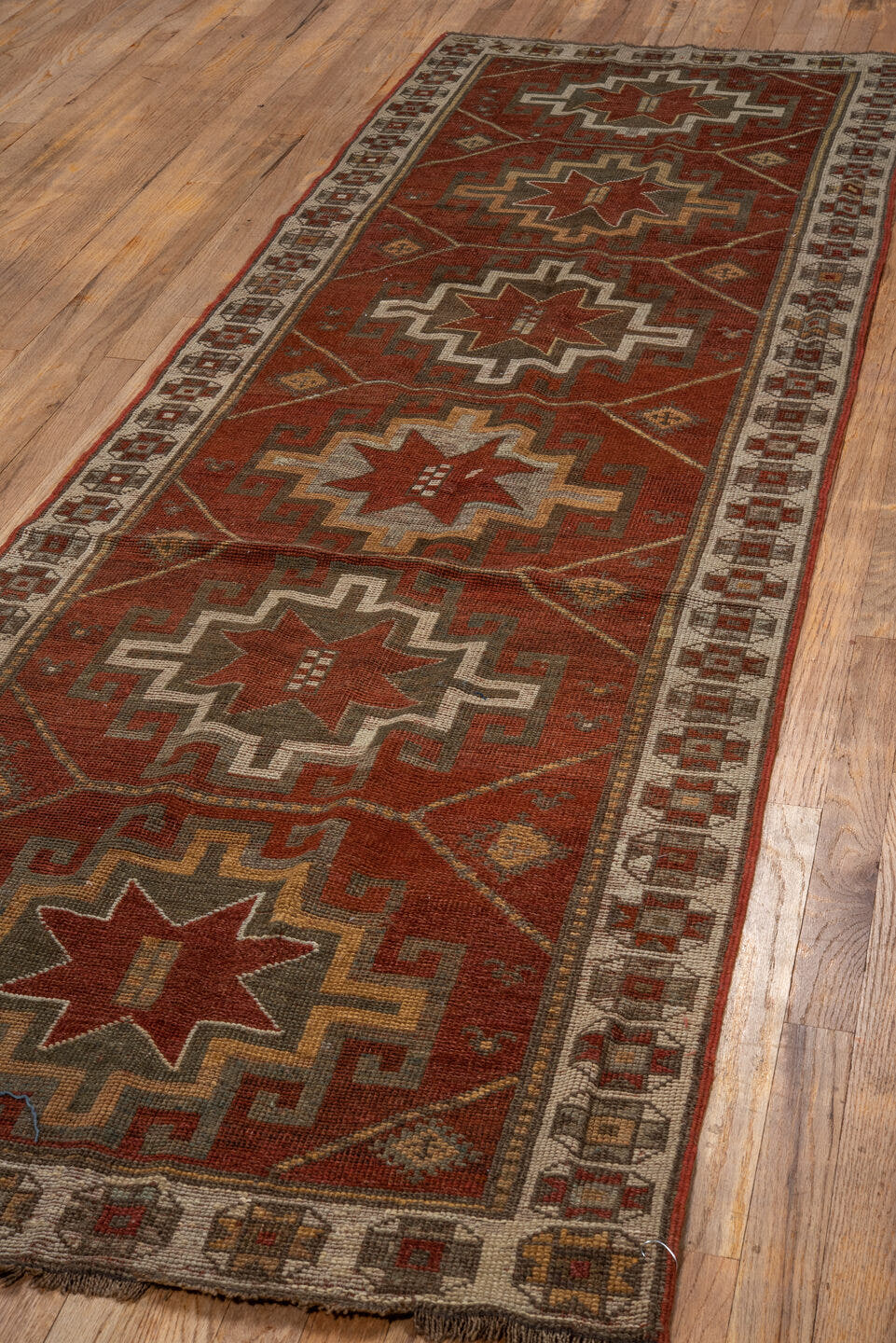 3' x 9' one-of-a-kind handmade antique Caucasian runner rug. Color palette: rust, ivory, brown, taupe, camel, gold, slate
