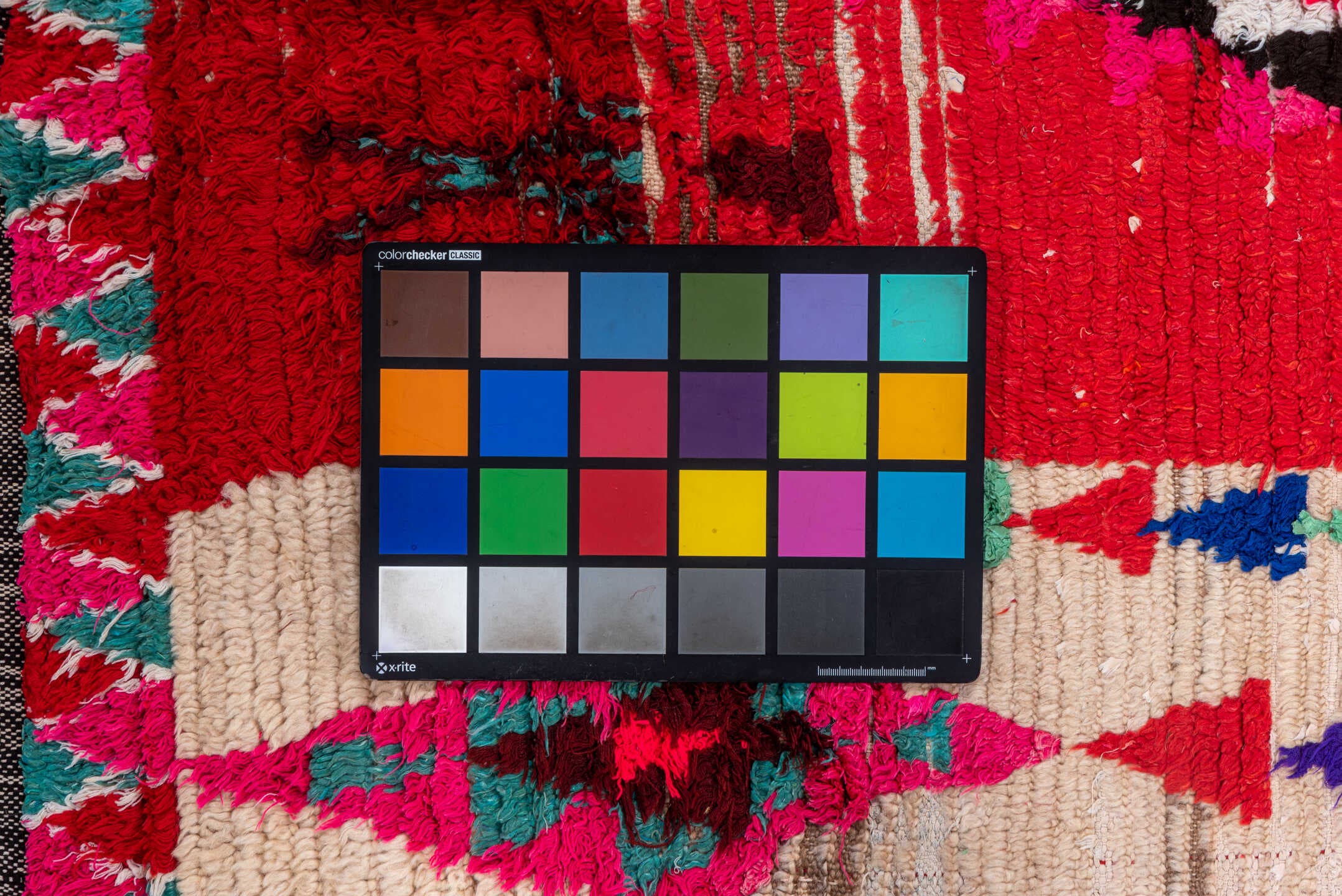 4' x 5' one-of-a-kind handmade vintage Moroccan small size rug. Color palette: red, ivory, black, fuchsia, turquoise