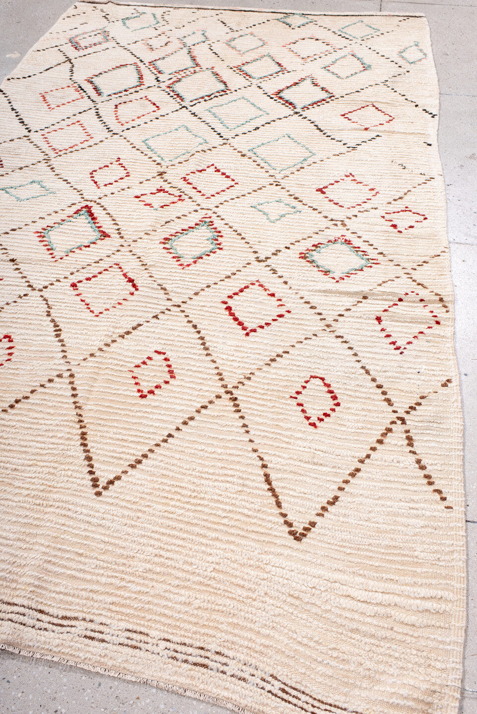 5' x 10' one-of-a-kind handmade vintage Moroccan medium size rug. Color palette: ivory, brown, red, aqua, cream, teal