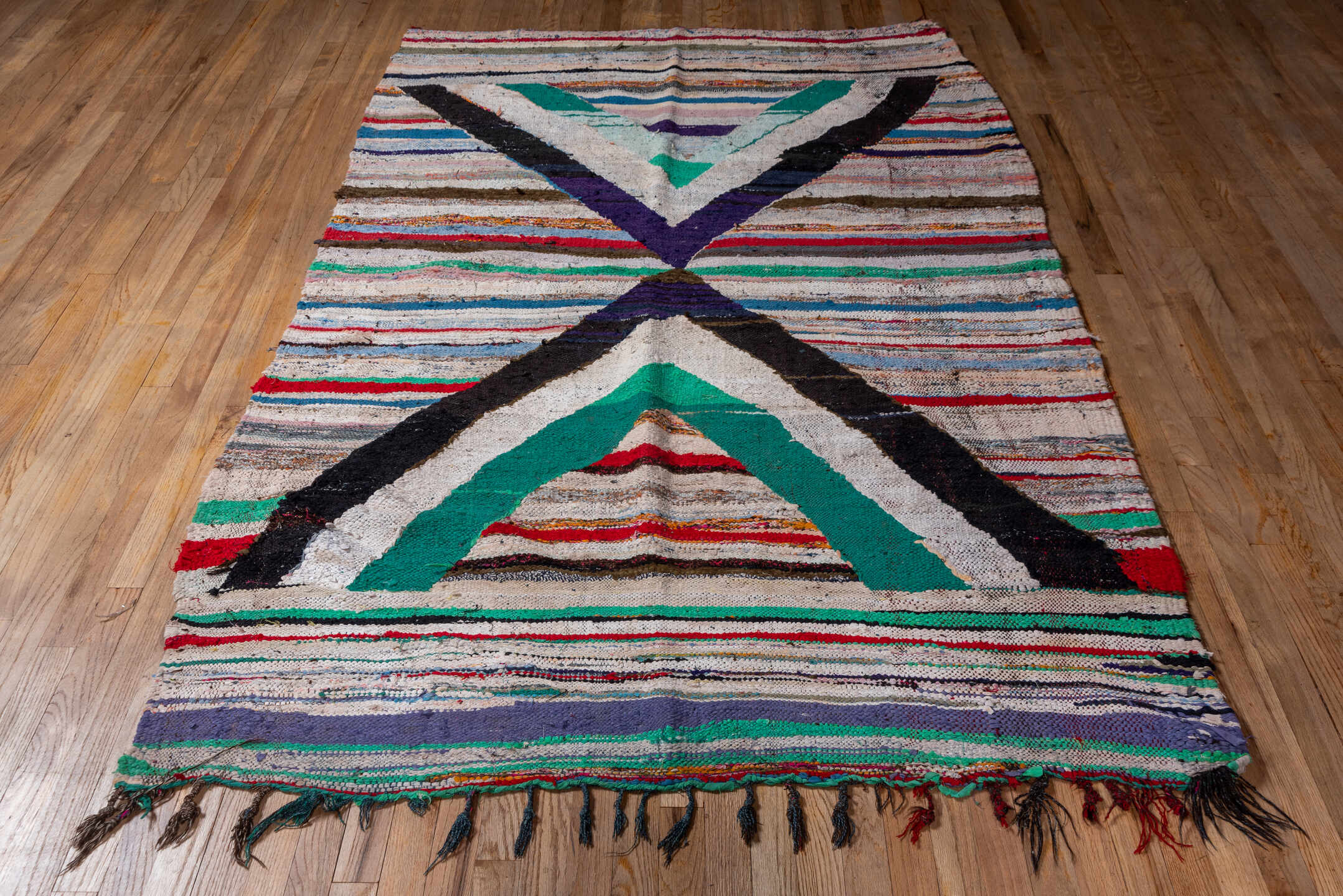 5' x 8' one-of-a-kind handmade vintage Rag Rug medium size rug. Color palette: ivory, black, teal, red, sky_blue, violet