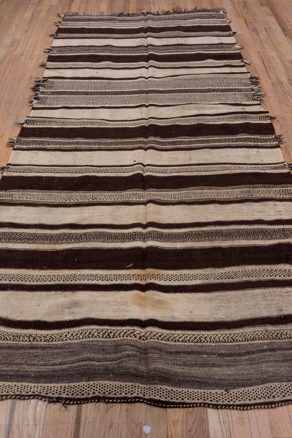 4' x 10' one-of-a-kind handmade vintage Blanket runner rug. Color palette: ivory, espresso, charcoal, taupe, brown, black