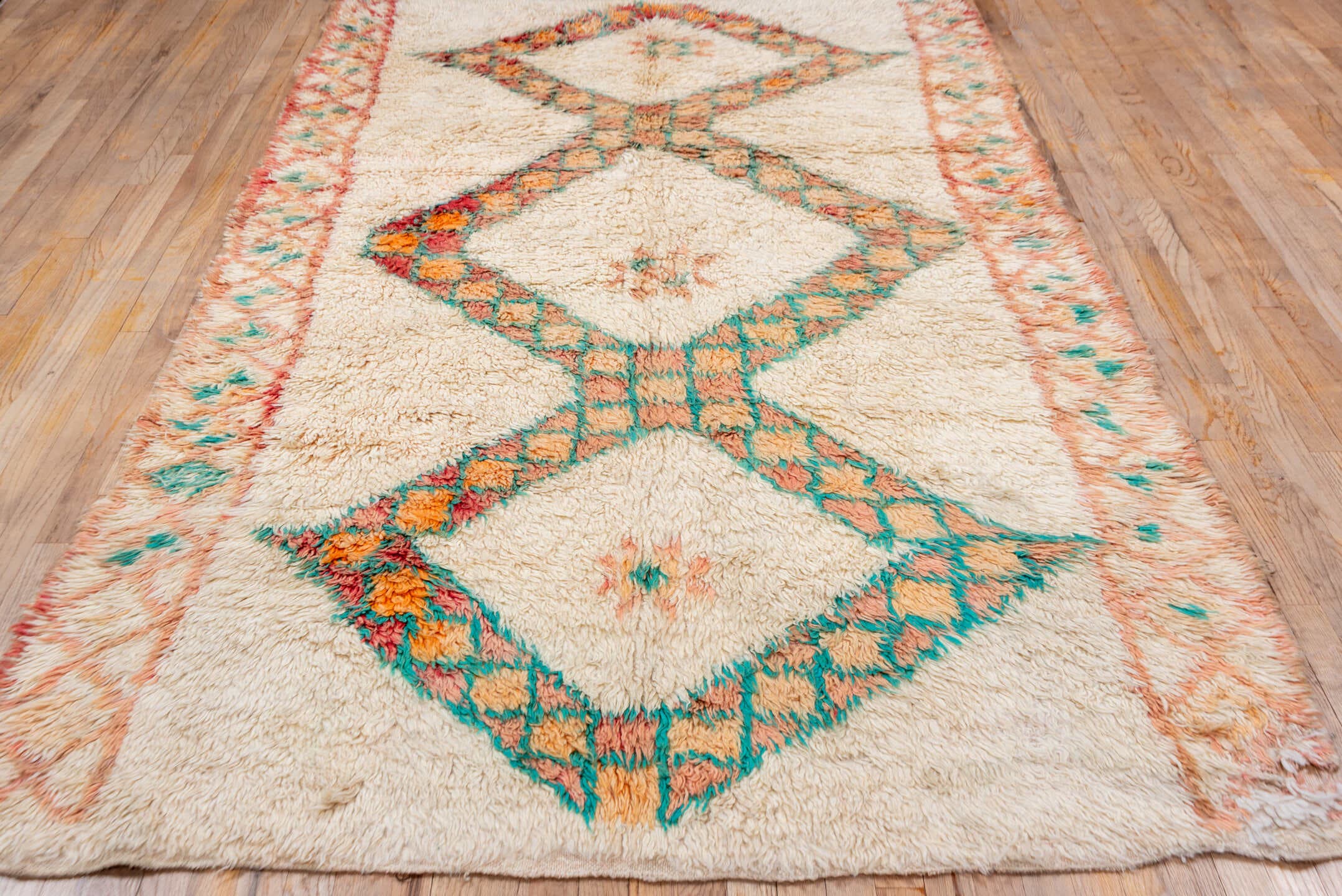 5' x 9' one-of-a-kind handmade vintage Moroccan medium size rug. Color palette: ivory, peach, teal, coral, orange, red