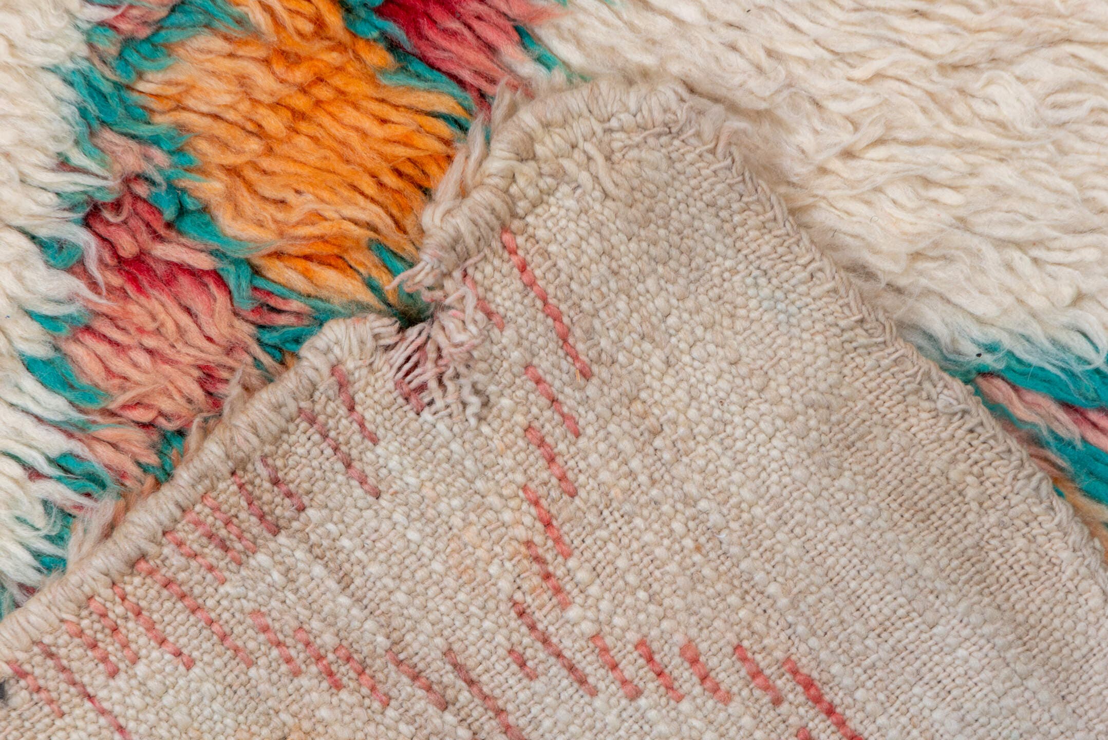 5' x 9' one-of-a-kind handmade vintage Moroccan medium size rug. Color palette: ivory, peach, teal, coral, orange, red