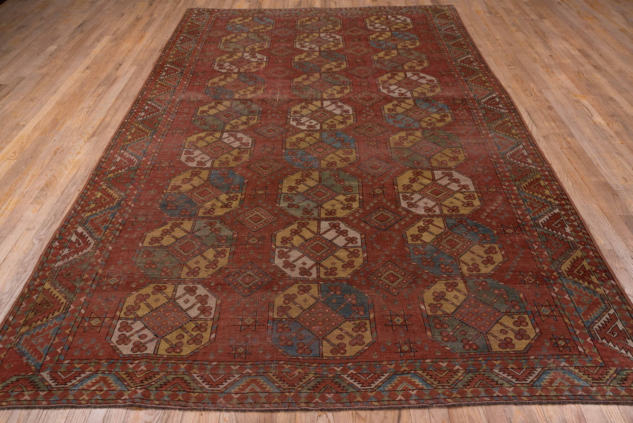 7' x 11' one-of-a-kind handmade antique Afghan large size rug. Color palette: rust, terra cotta, camel, ivory, slate blue