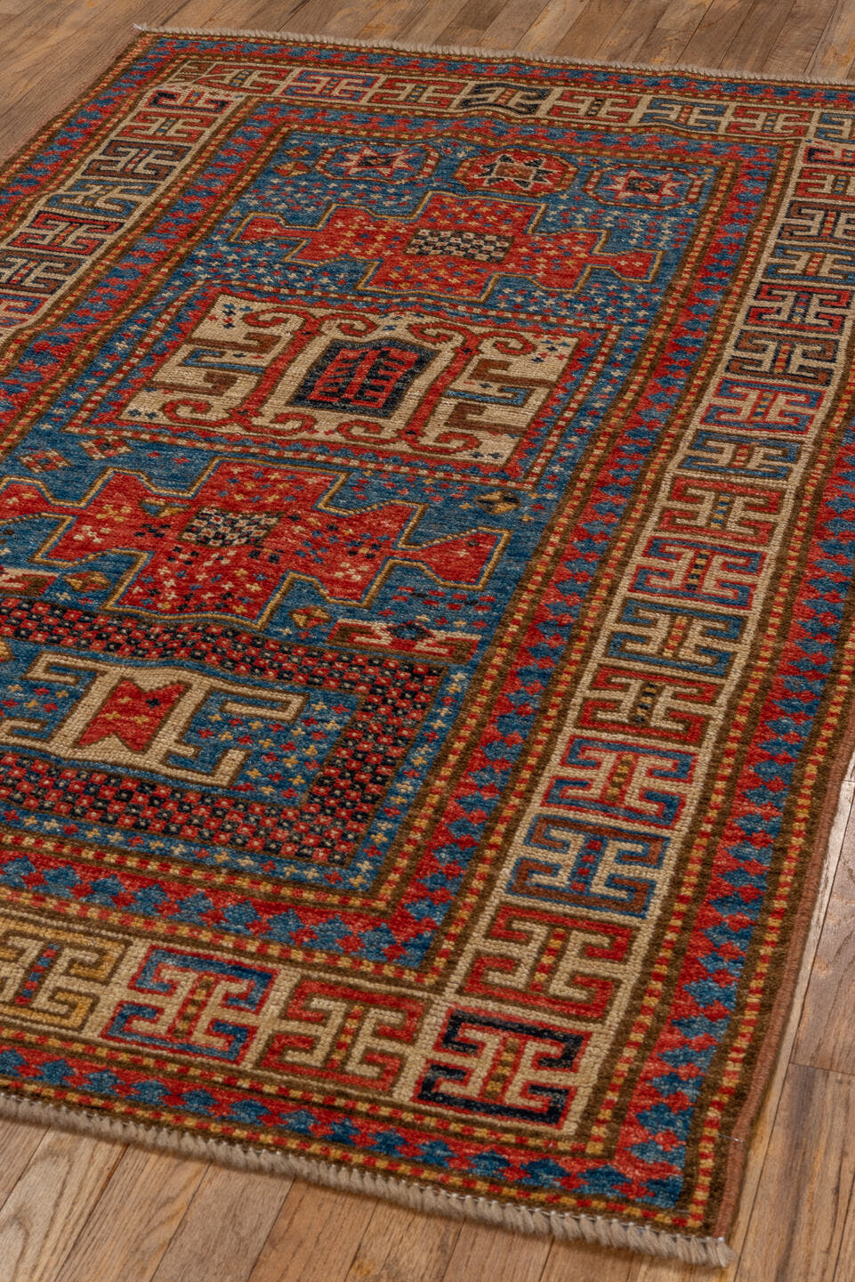 4' x 6' one-of-a-kind handmade vintage Kazak small size rug. Color palette: blue, ivory, red, camel, navy, brown, black