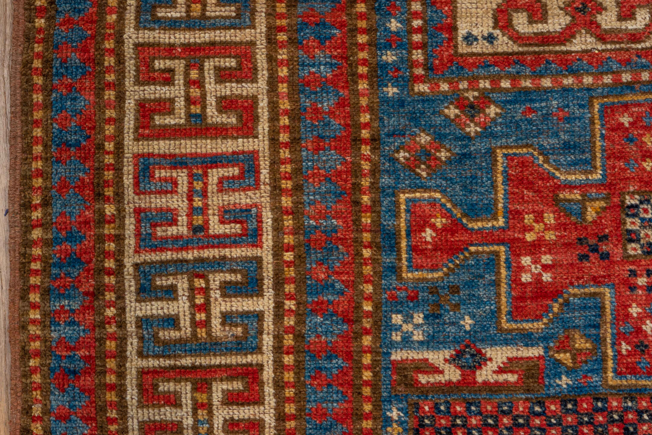 4' x 6' one-of-a-kind handmade vintage Kazak small size rug. Color palette: blue, ivory, red, camel, navy, brown, black