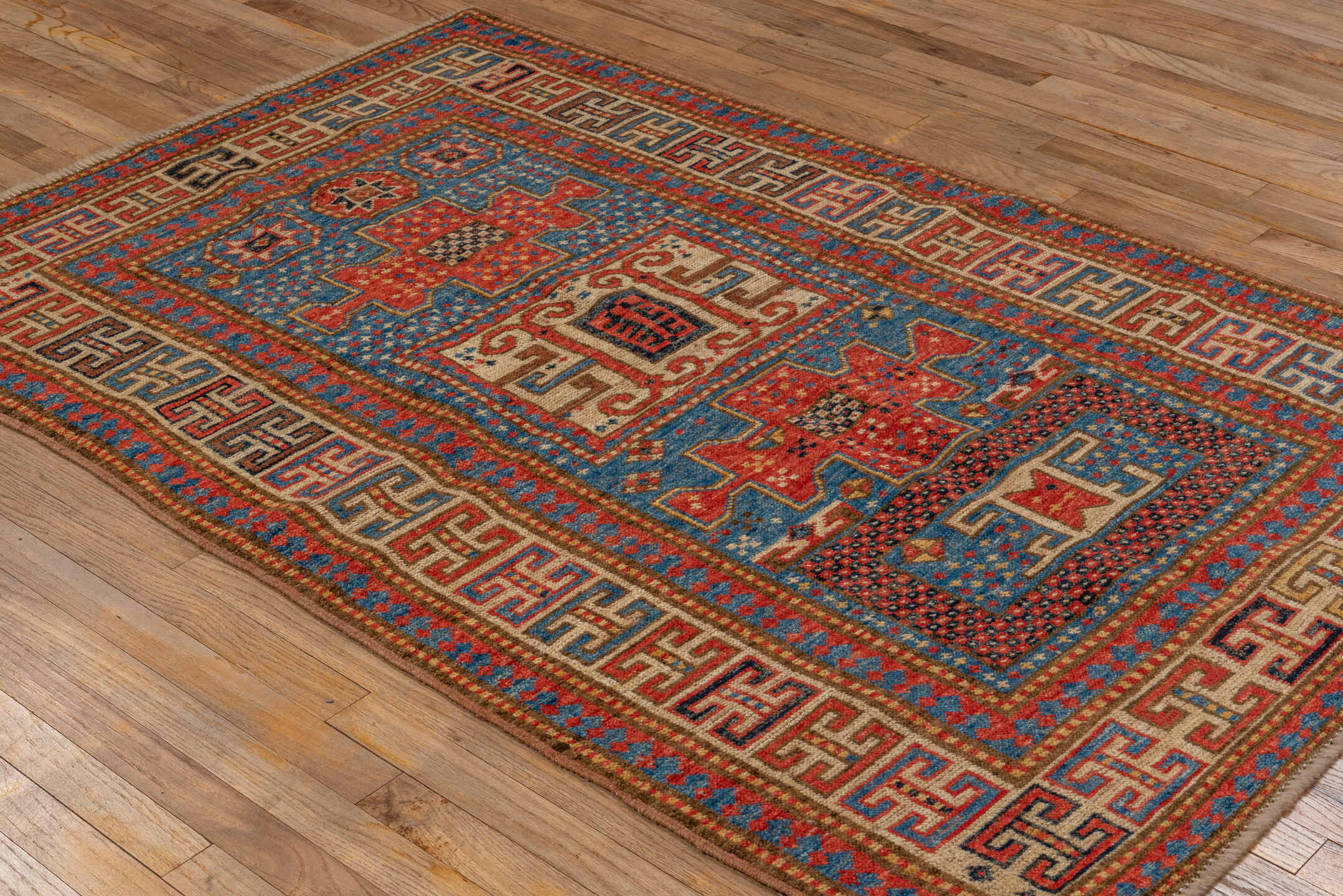 4' x 6' one-of-a-kind handmade vintage Kazak small size rug. Color palette: blue, ivory, red, camel, navy, brown, black