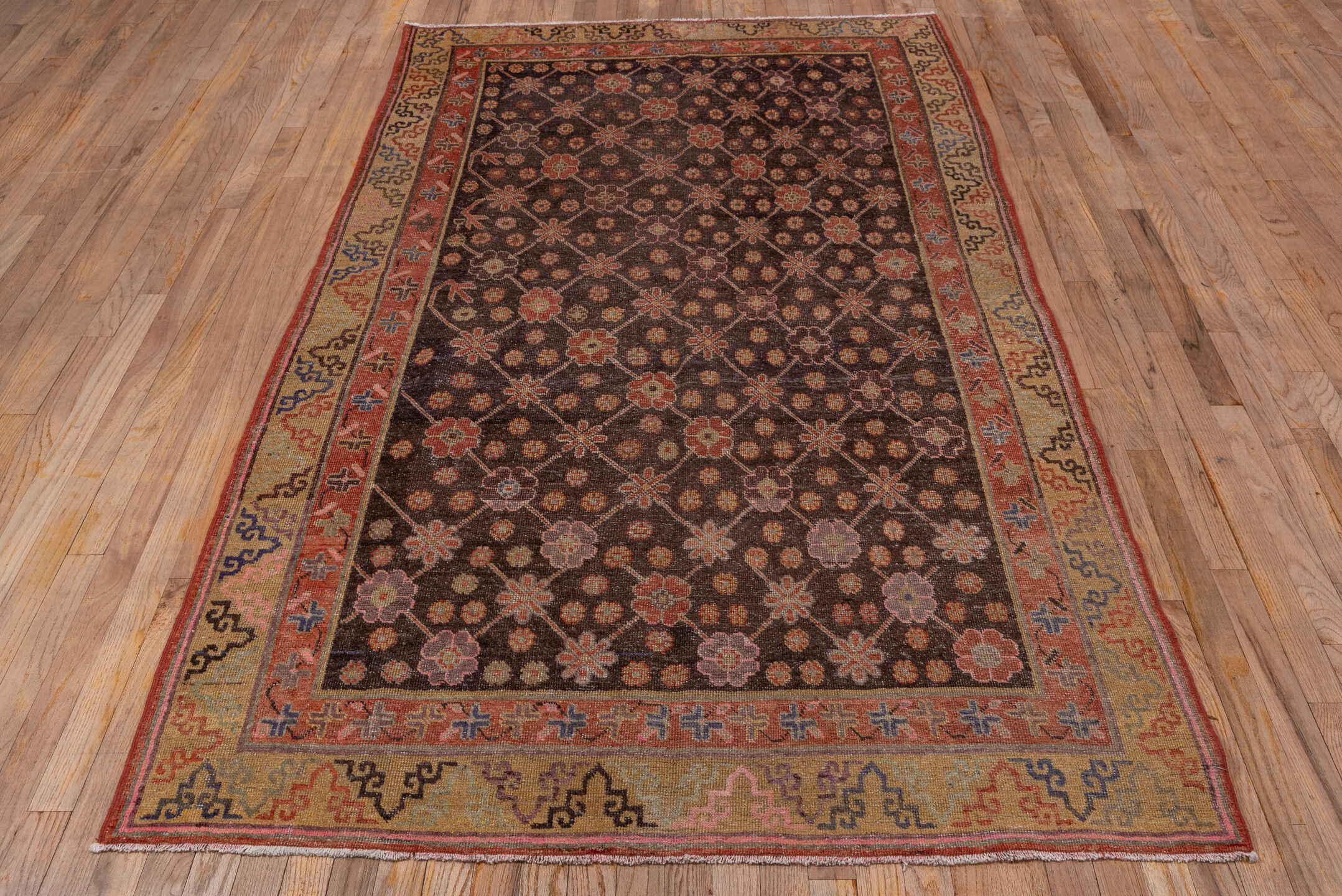 4' x 8' one-of-a-kind handmade vintage Khotan rug. Color palette: brown, rust, camel, ivory, rose, blue, charcoal