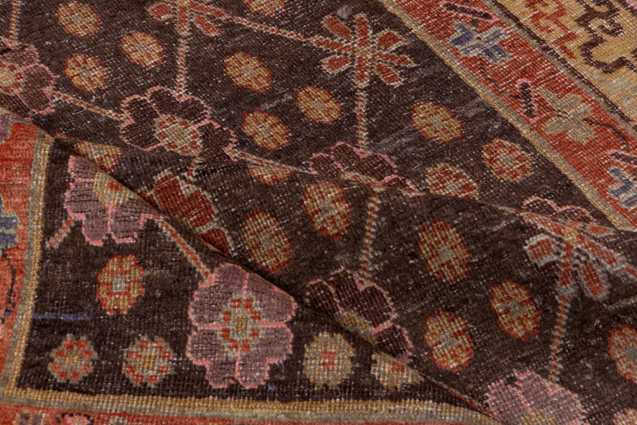 4' x 8' one-of-a-kind handmade vintage Khotan rug. Color palette: brown, rust, camel, ivory, rose, blue, charcoal