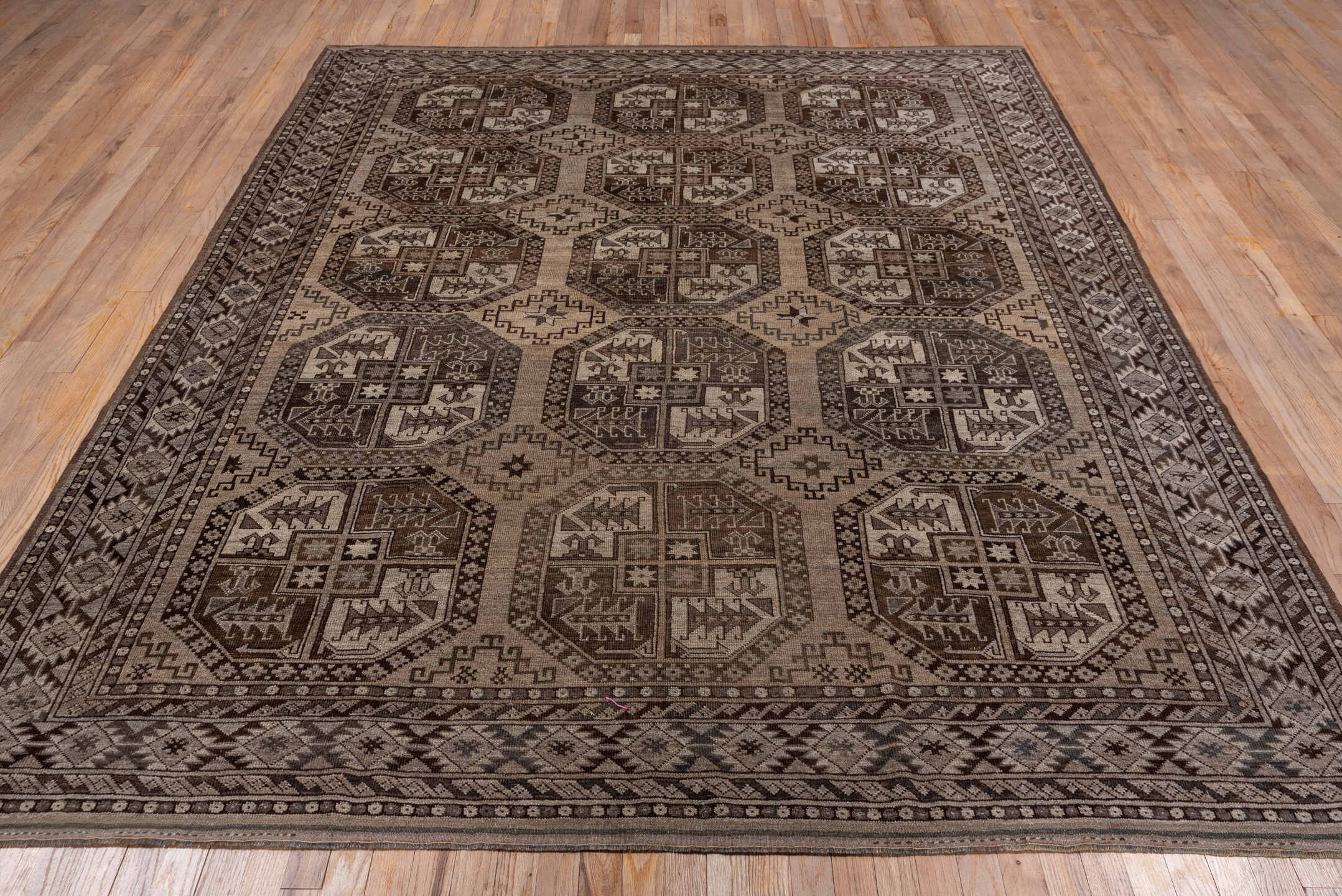 7' x 9' one-of-a-kind handmade antique Afghan rug. Color palette: brown, taupe, ivory, charcoal, camel, slate, beige, gray