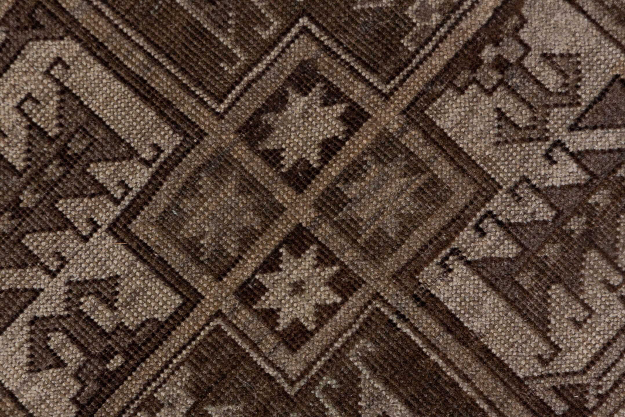 7' x 9' one-of-a-kind handmade antique Afghan rug. Color palette: brown, taupe, ivory, charcoal, camel, slate, beige, gray