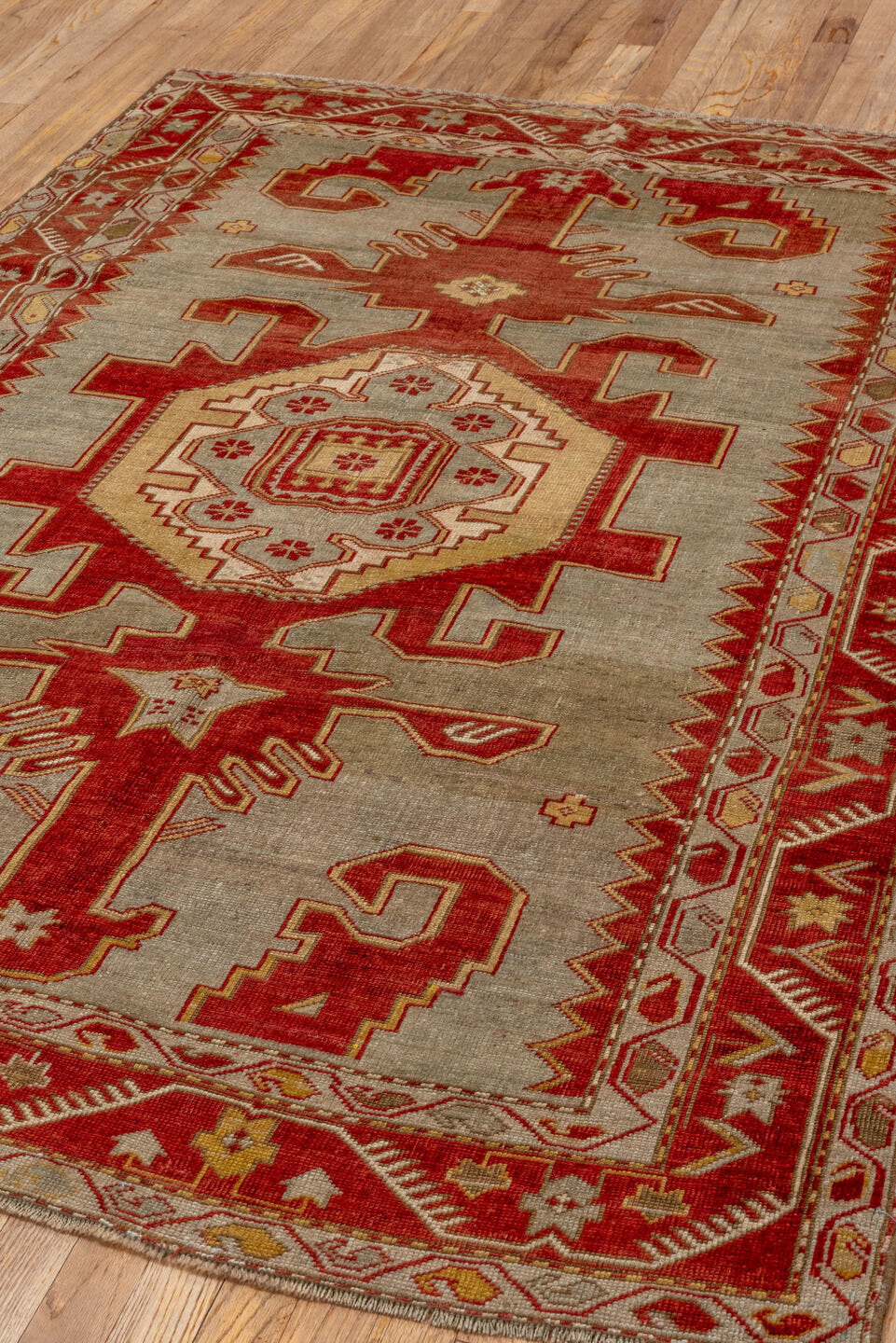 4' x 6' one-of-a-kind handmade antique Caucasian rug. Color palette: ivory, rust, crimson, camel, gold, taupe, terracotta