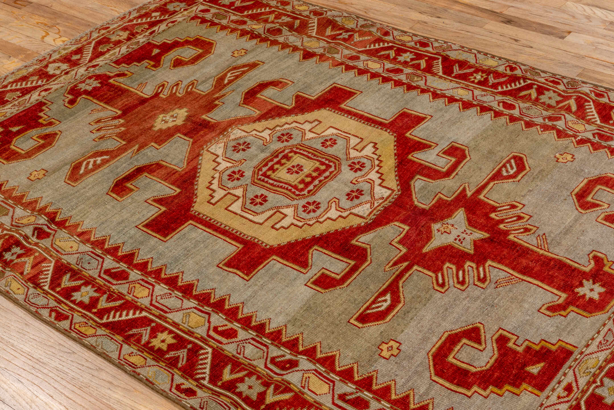 4' x 6' one-of-a-kind handmade antique Caucasian rug. Color palette: ivory, rust, crimson, camel, gold, taupe, terracotta