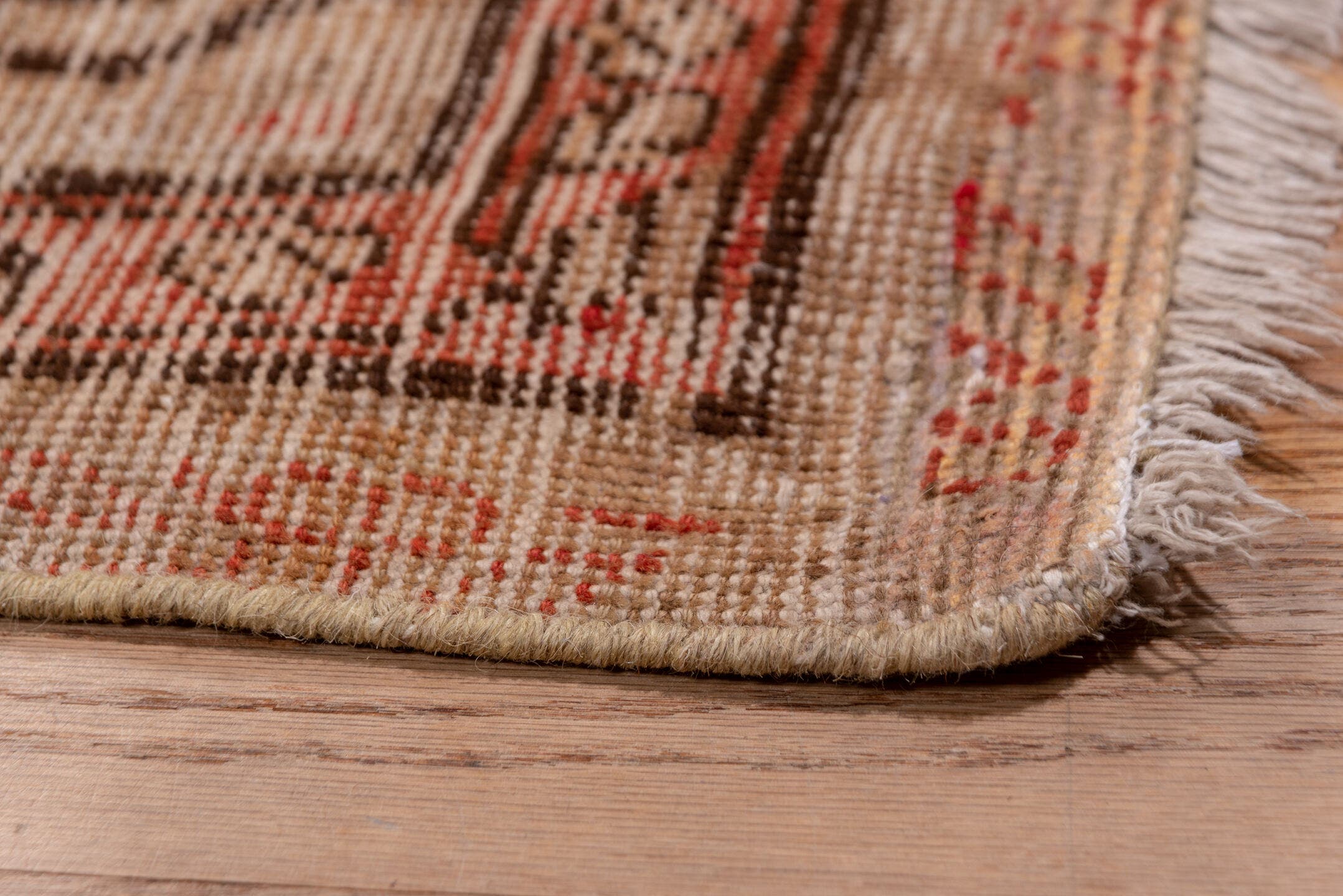 5' x 11' one-of-a-kind handmade antique Khotan rug. Color palette: ivory, terra cotta, taupe, charcoal, rose, camel