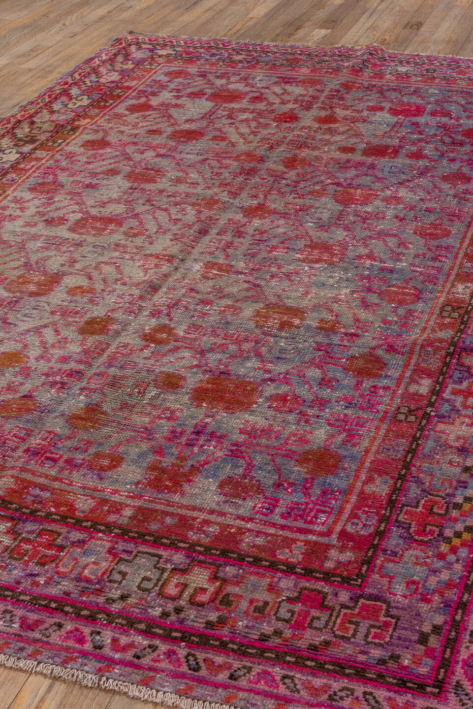 5' x 9' one-of-a-kind handmade antique Khotan medium size rug. Color palette: pink, rose, crimson, ivory, lavender, burgundy