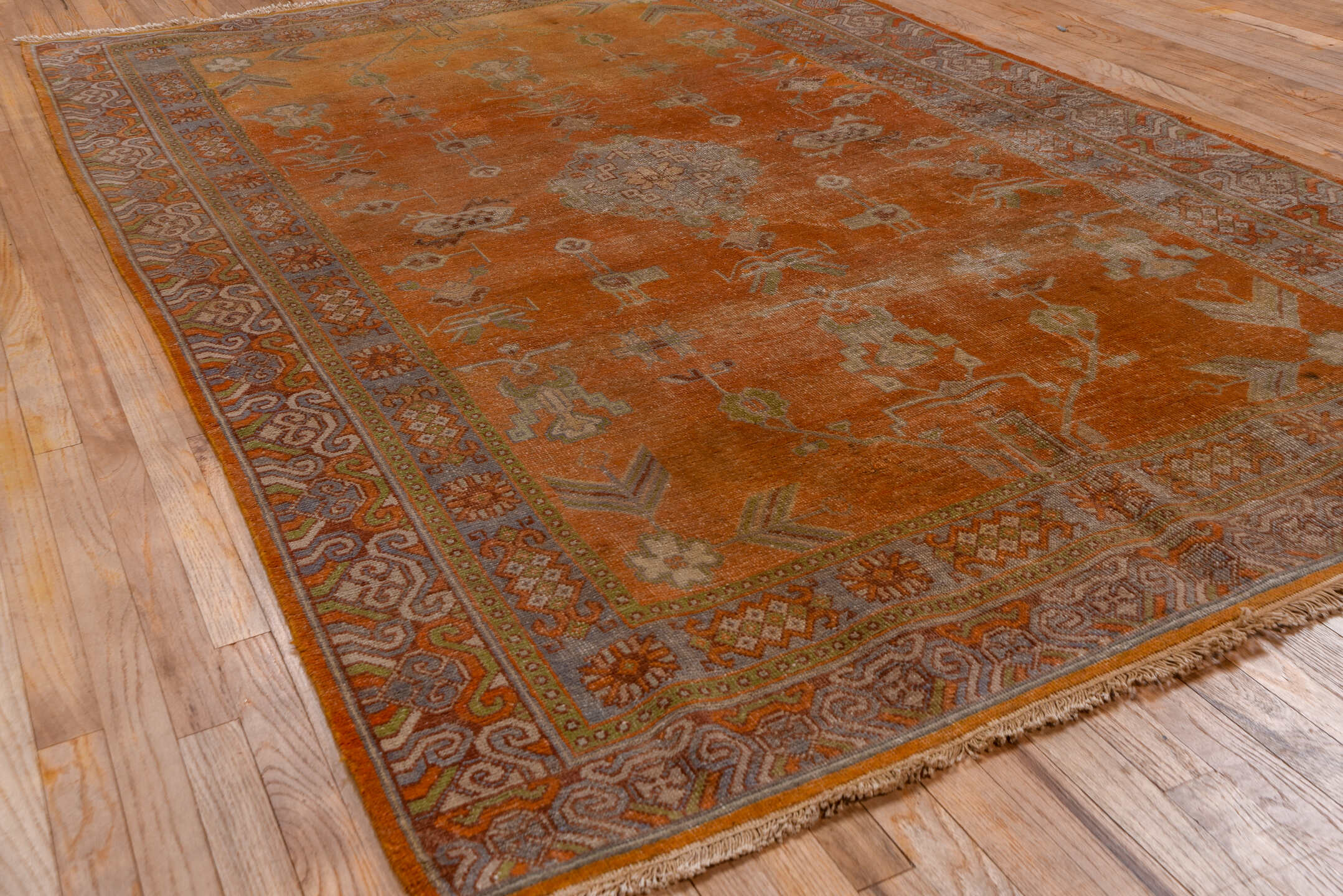 5' x 9' one-of-a-kind handmade antique Khotan medium size rug. Color palette: terra cotta, taupe, rust, camel, ivory, sienna