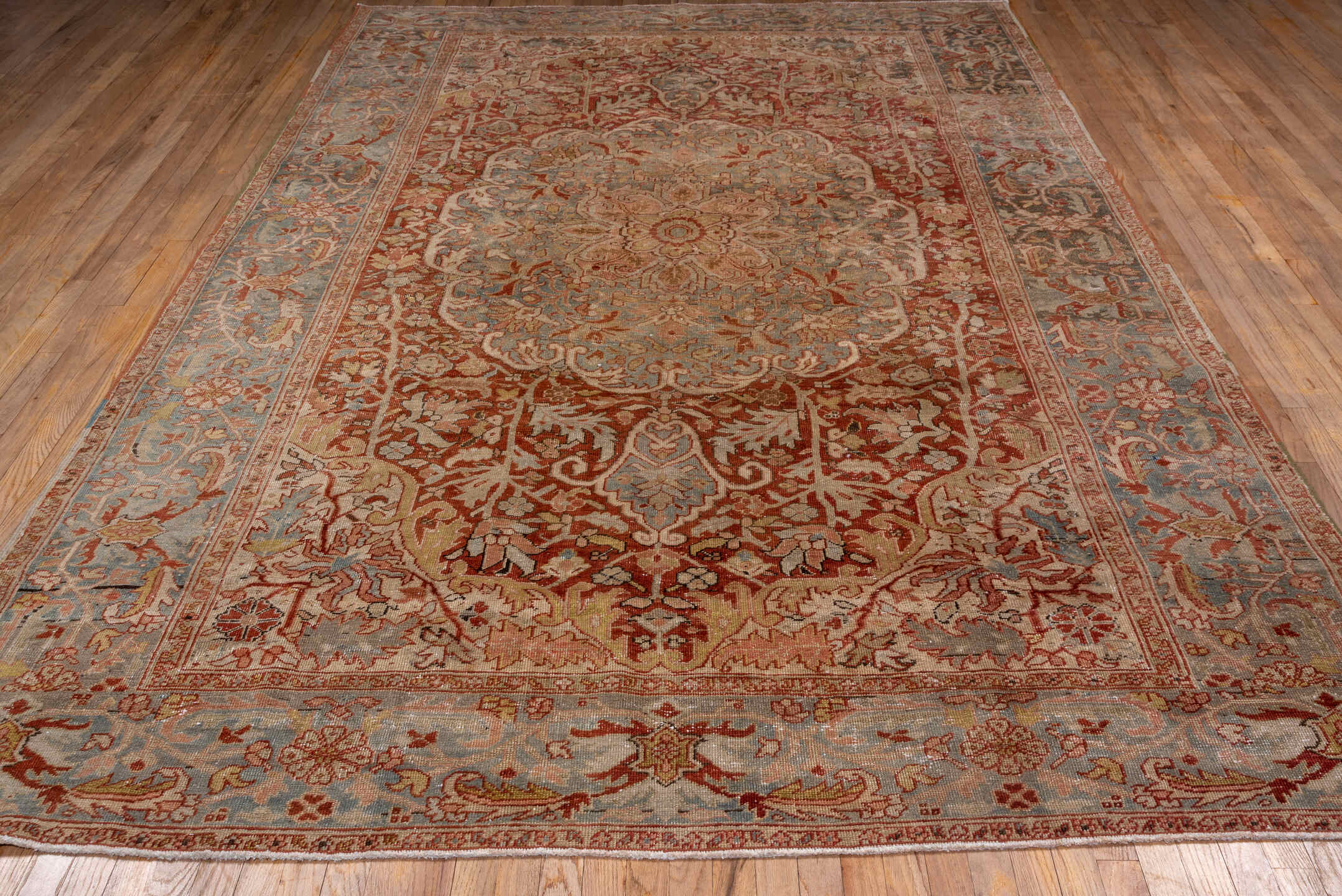 7' x 11' one-of-a-kind handmade antique Heriz large size rug. Color palette: terra cotta, light blue, ivory, rust, sage