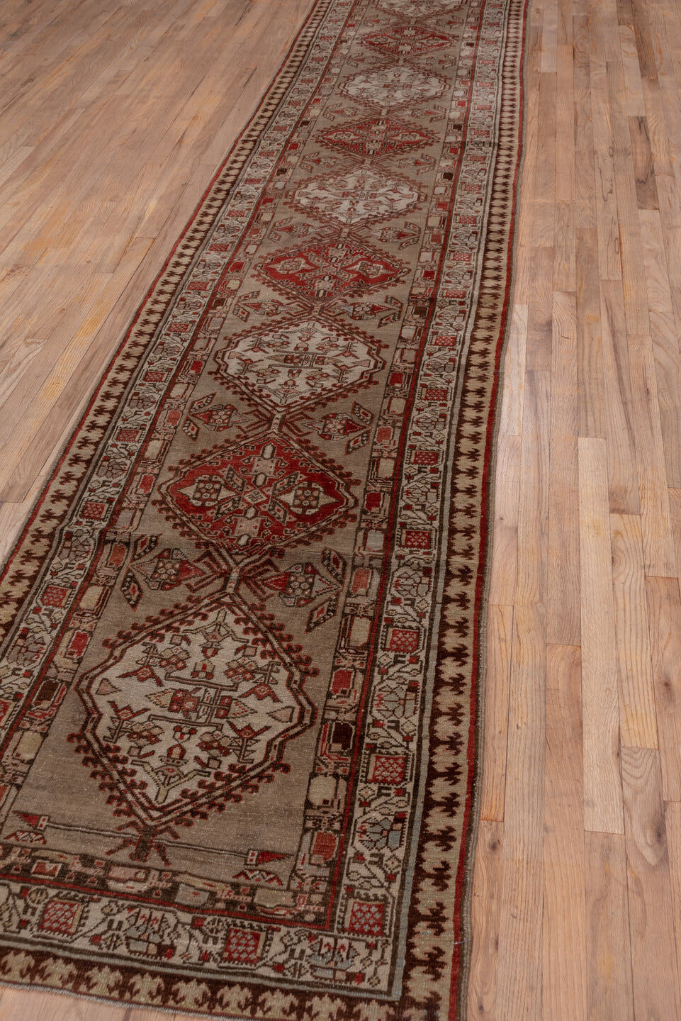 3' x 16' one-of-a-kind handmade antique Sarab runner rug. Color palette: ivory, rust, brown, camel, taupe, brick, charcoal