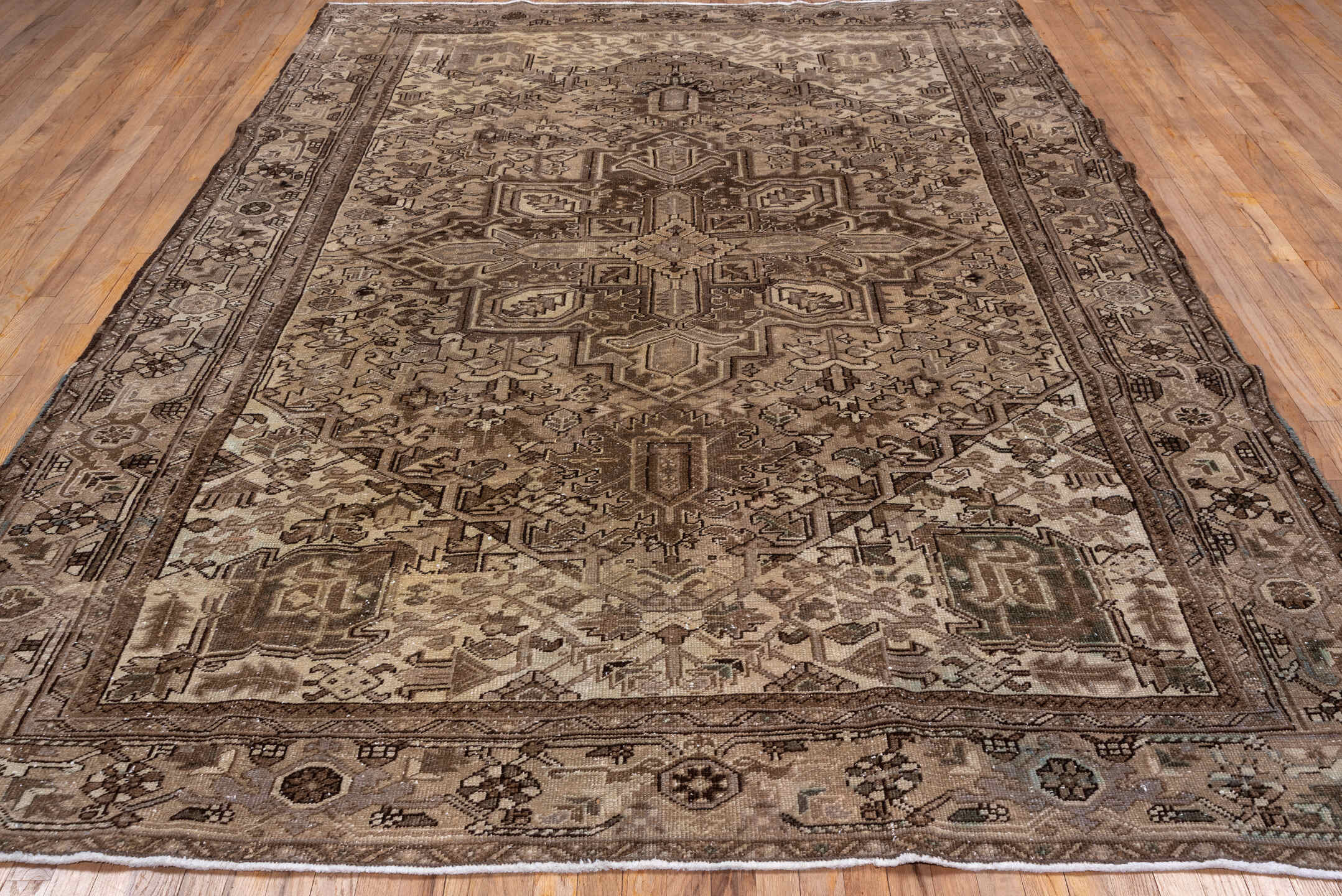 7' x 10' one-of-a-kind handmade antique Heriz large size rug. Color palette: taupe, camel, ivory, brown, beige, charcoal