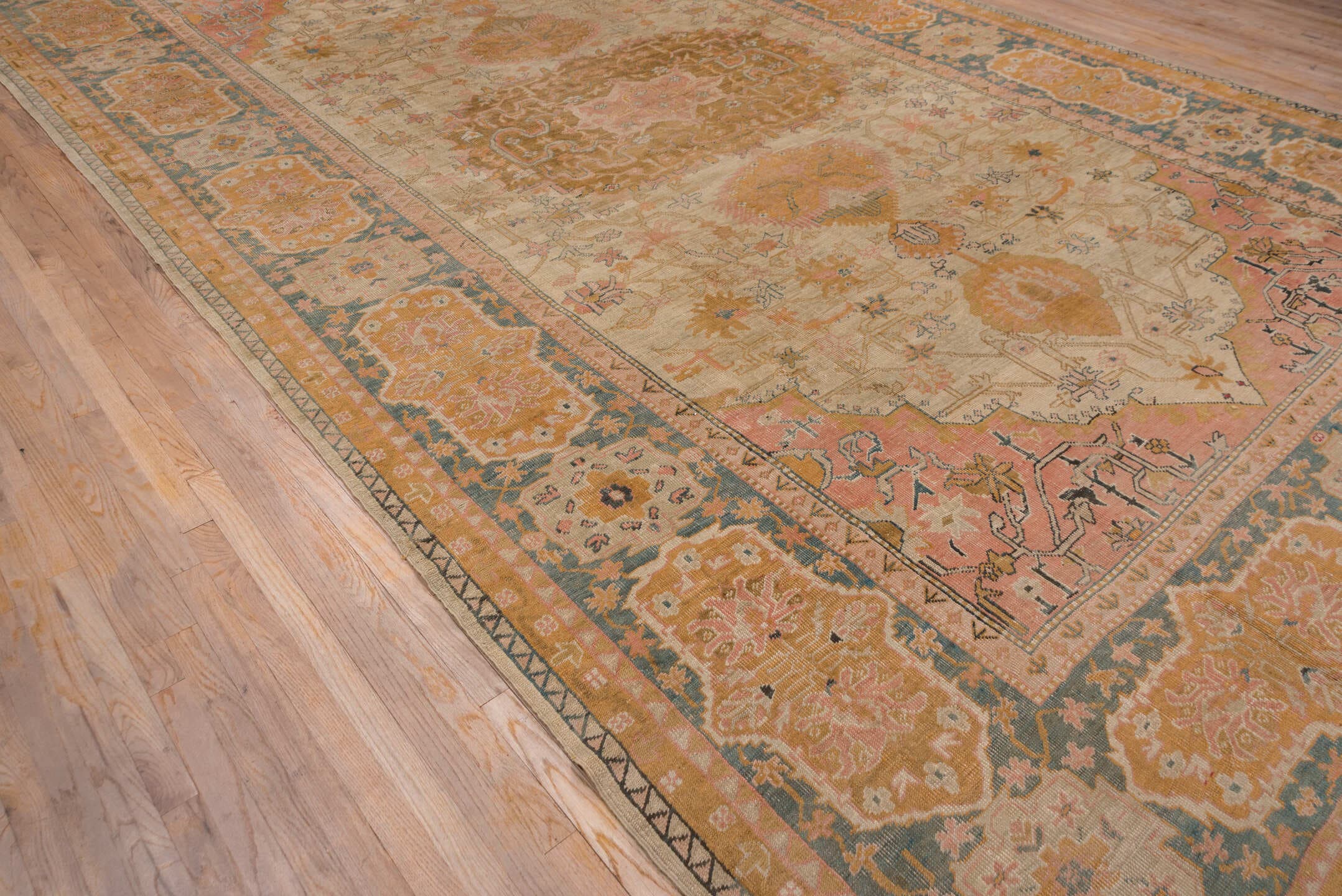 11' x 18' one-of-a-kind handmade antique Oushak oversize rug. Color palette: ivory, apricot, gold, sage, terra cotta, taupe