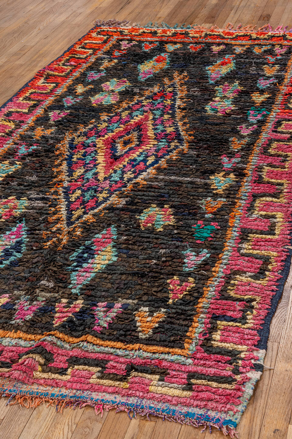 4' x 8' one-of-a-kind handmade vintage Rag Rug rug. Color palette: charcoal, hot pink, orange, turquoise, gold, cream, black
