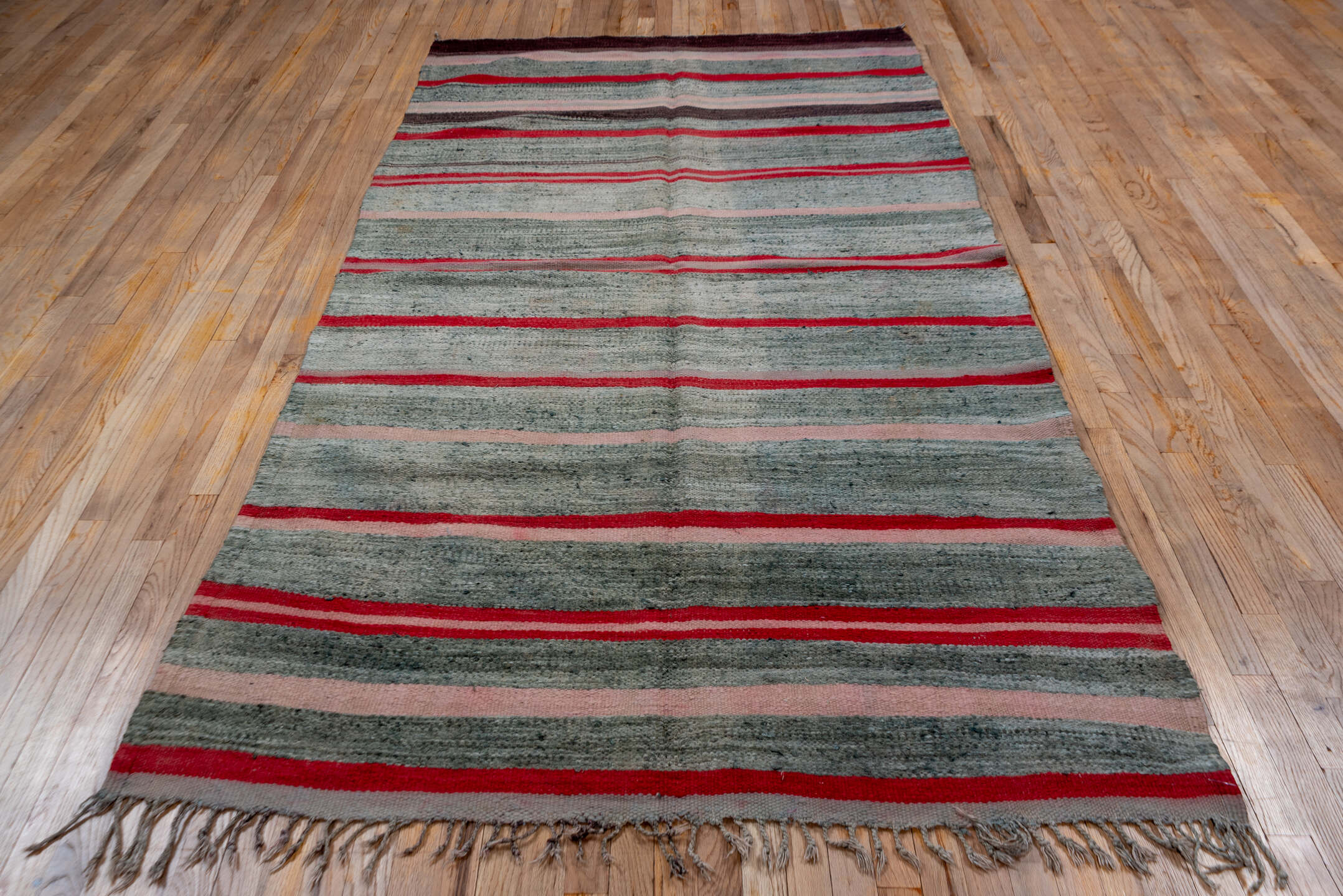5' x 9' one-of-a-kind handmade vintage Blanket medium size rug. Color palette: brown, gray, light gray, off-white, pink, red