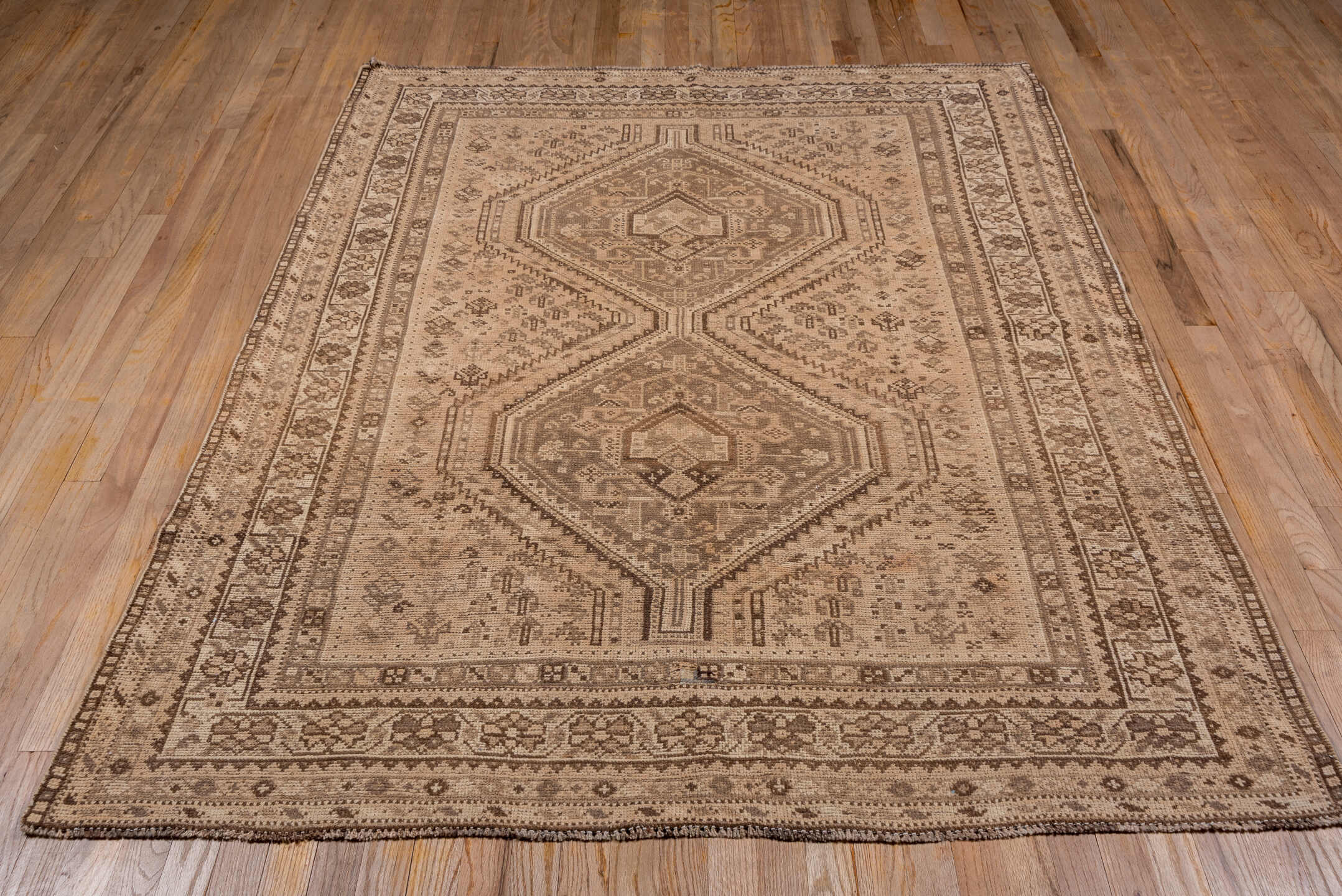 5' x 6' one-of-a-kind handmade antique Shiraz rug. Color palette: camel, taupe, brown, beige, ivory, gray