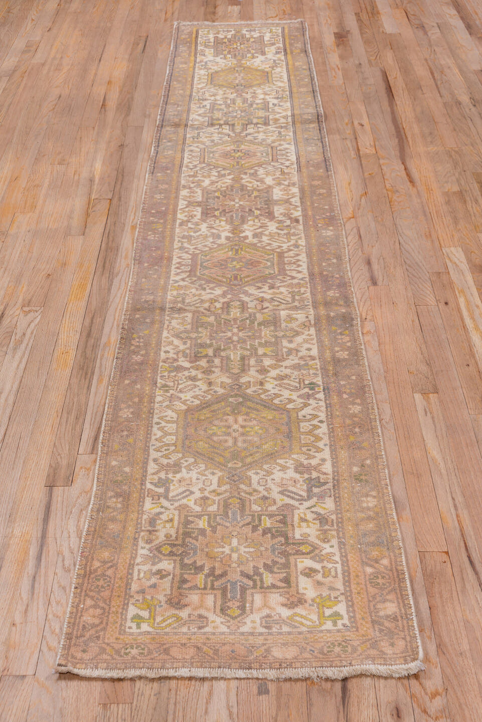 2' x 10' one-of-a-kind handmade antique Karaje runner rug. Color palette: taupe, ivory, camel, gold, sage, brown, beige