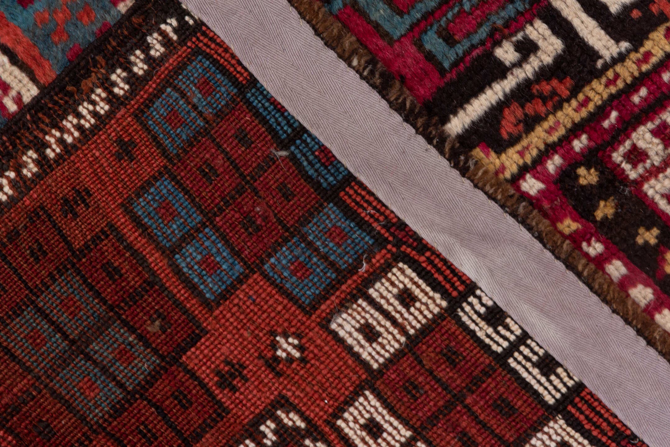 4' x 10' one-of-a-kind handmade antique Caucasian runner rug. Color palette: rust, ivory, indigo, crimson, sky_blue, gold