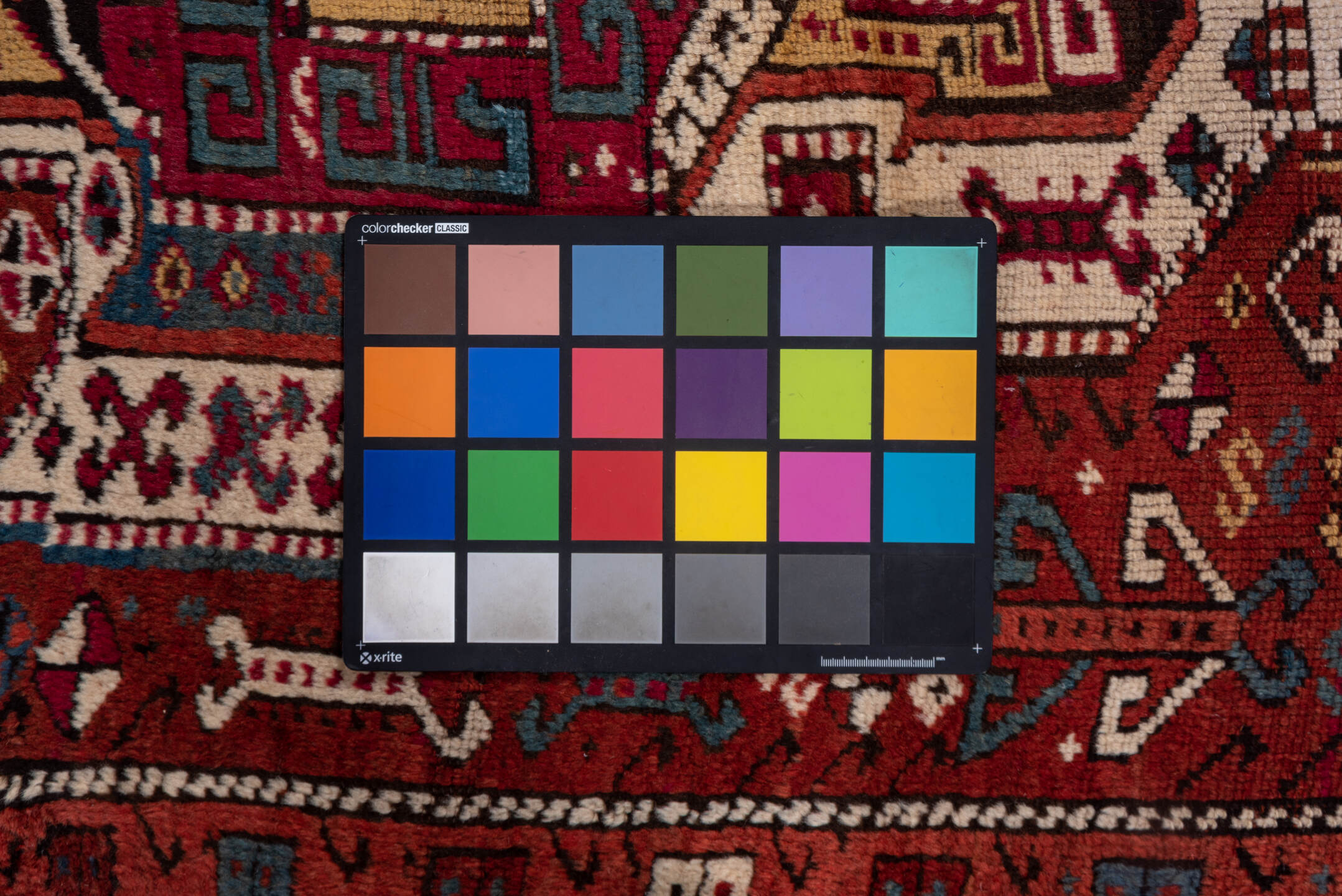 4' x 10' one-of-a-kind handmade vintage Caucasian runner rug. Color palette: black, blue, brown, dim gray, gray, pink, red