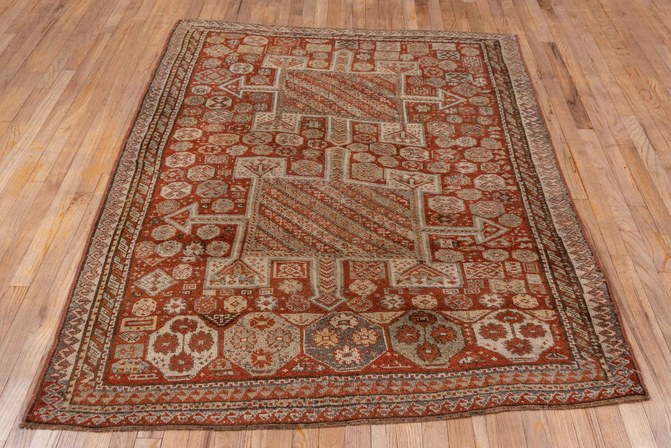 4' x 7' one-of-a-kind handmade antique Kurd rug. Color palette: rust, ivory, terra cotta, brown, taupe, charcoal, terracotta