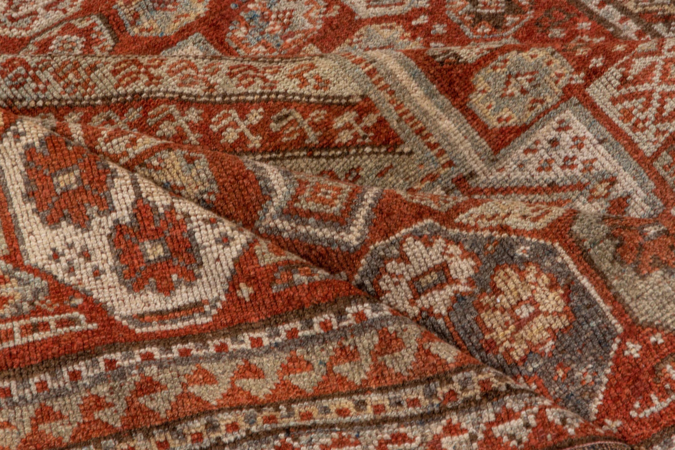 4' x 7' one-of-a-kind handmade antique Kurd rug. Color palette: rust, ivory, terra cotta, brown, taupe, charcoal, terracotta