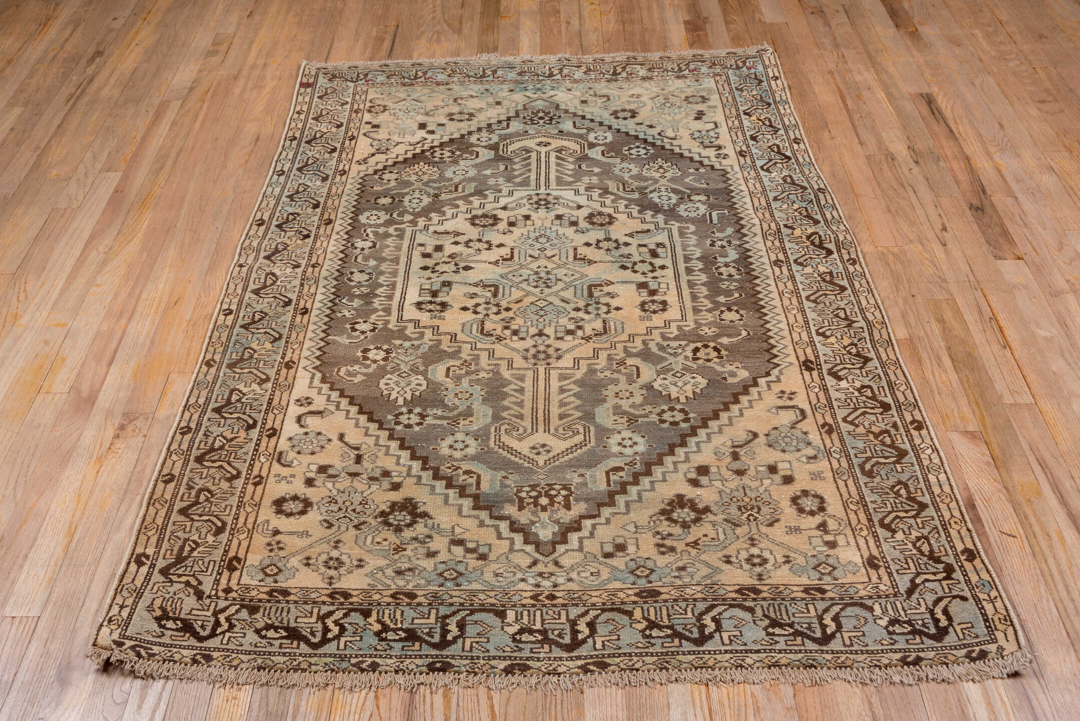 4' x 6' one-of-a-kind handmade antique Shiraz small size rug. Color palette: ivory, taupe, brown, pale blue, camel, charcoal