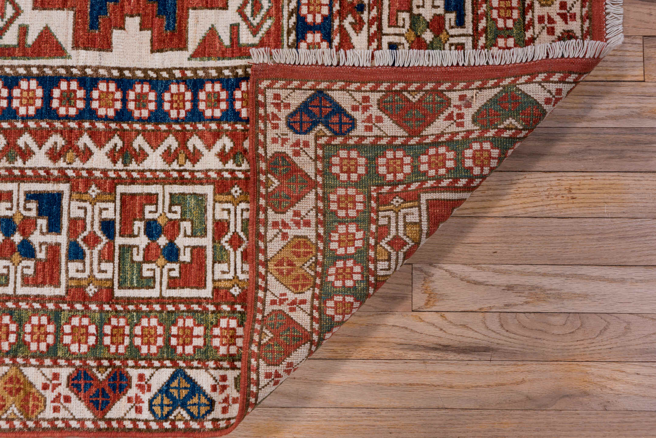 4' x 7' one-of-a-kind handmade vintage Kazak rug. Color palette: ivory, rust, indigo, olive, gold, terra cotta, terracotta