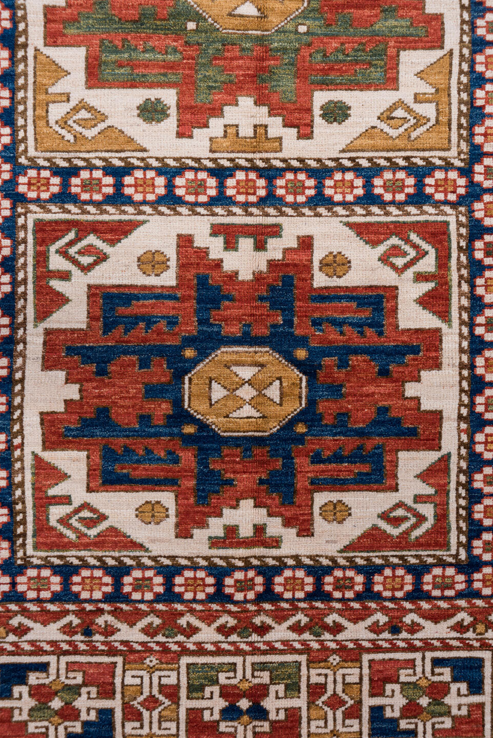 4' x 7' one-of-a-kind handmade vintage Kazak rug. Color palette: ivory, rust, indigo, olive, gold, terra cotta, terracotta
