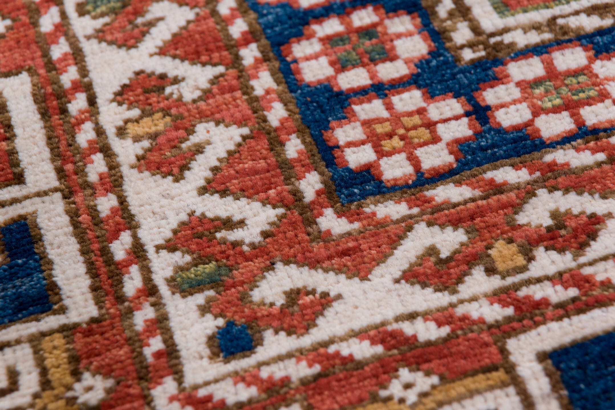 4' x 7' one-of-a-kind handmade vintage Kazak rug. Color palette: ivory, rust, indigo, olive, gold, terra cotta, terracotta
