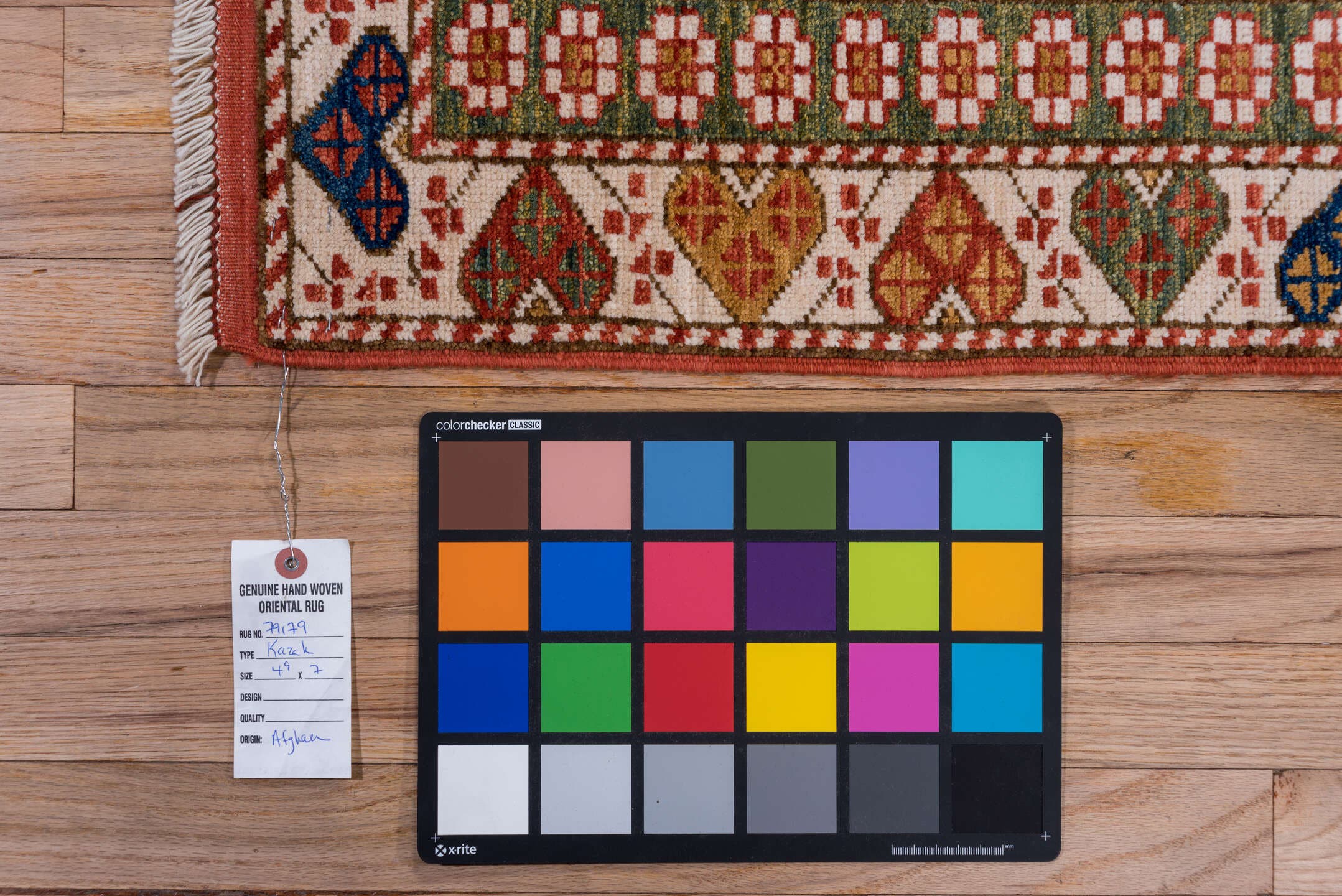 4' x 7' one-of-a-kind handmade vintage Kazak rug. Color palette: ivory, rust, indigo, olive, gold, terra cotta, terracotta