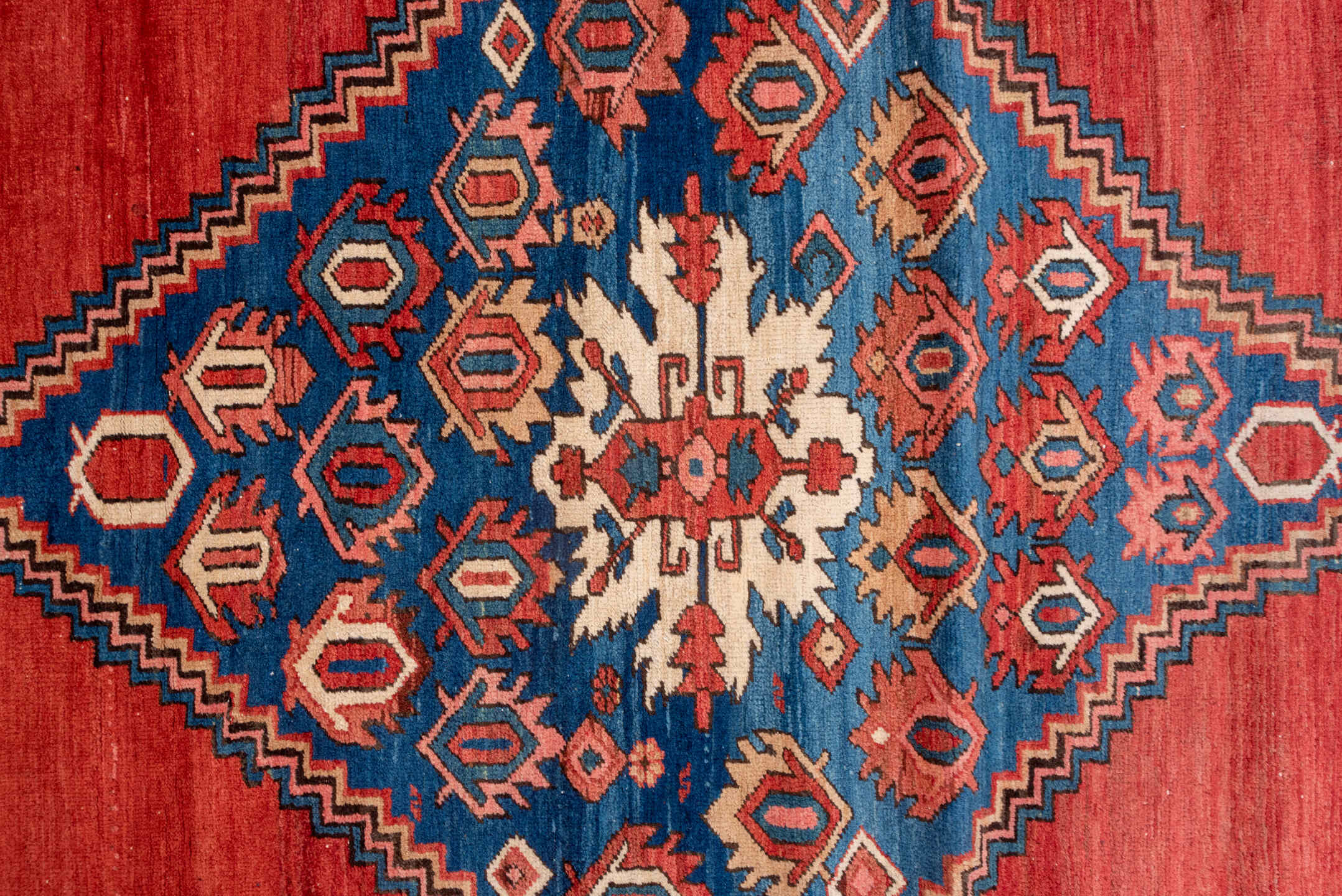 15' x 20' one-of-a-kind handmade antique Serapi oversize rug. Color palette: terra cotta, indigo, ivory, rust, coral, navy