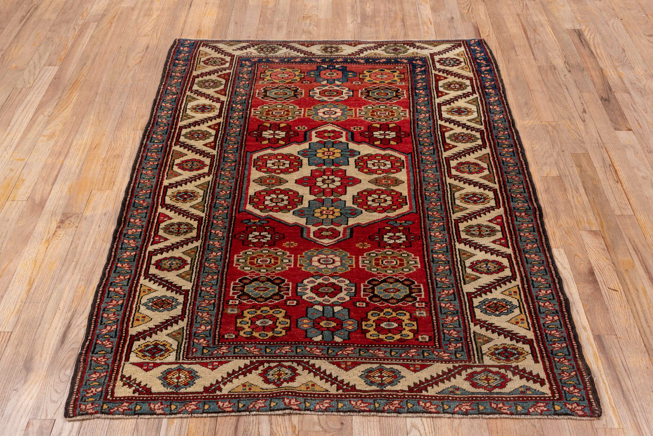 4' x 5' one-of-a-kind handmade antique NW Persian small size rug. Color palette: red, ivory, blue, burgundy, gold, camel