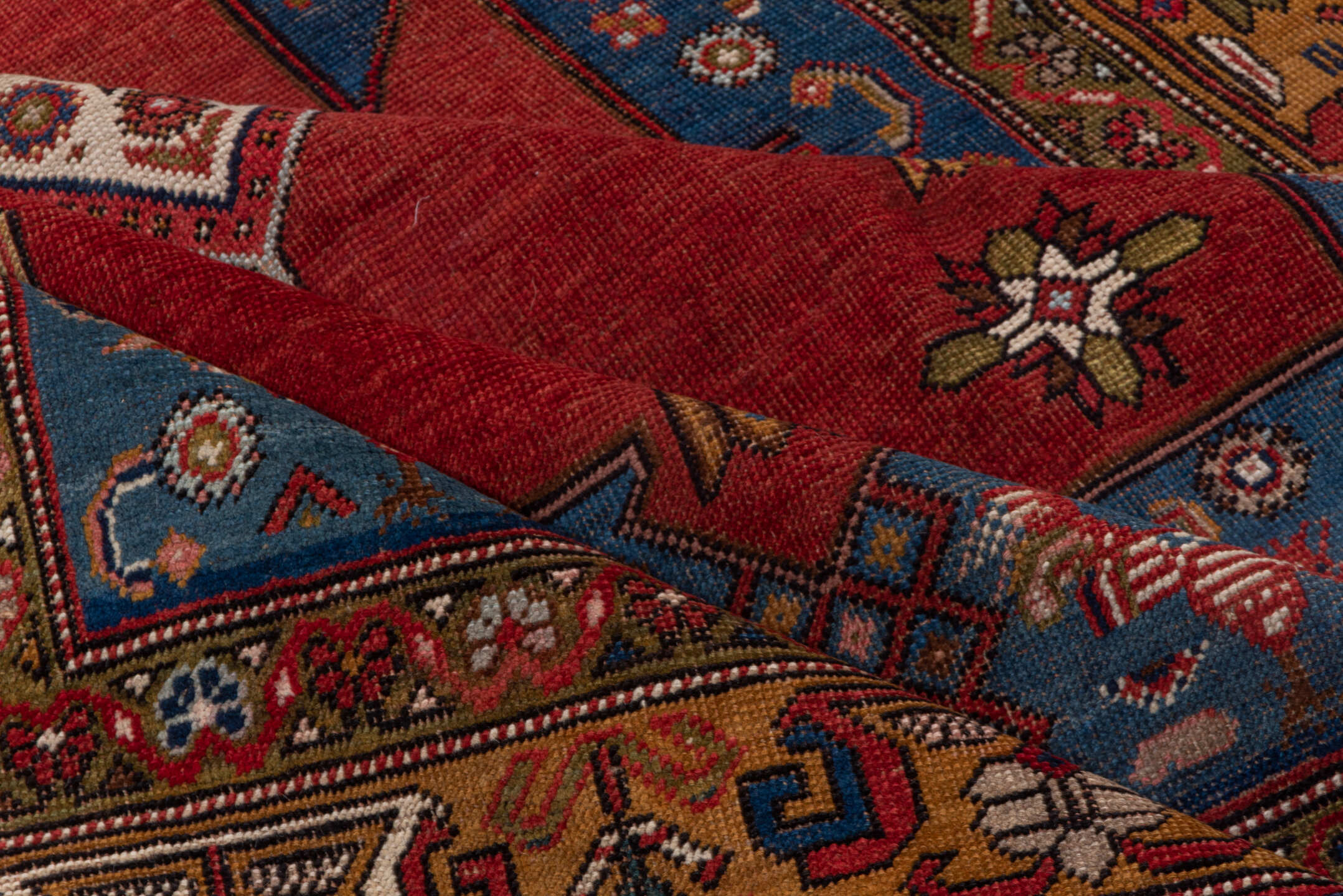5' x 6' one-of-a-kind handmade vintage Caucasian rug. Color palette: blue, brown, gray, pink, red