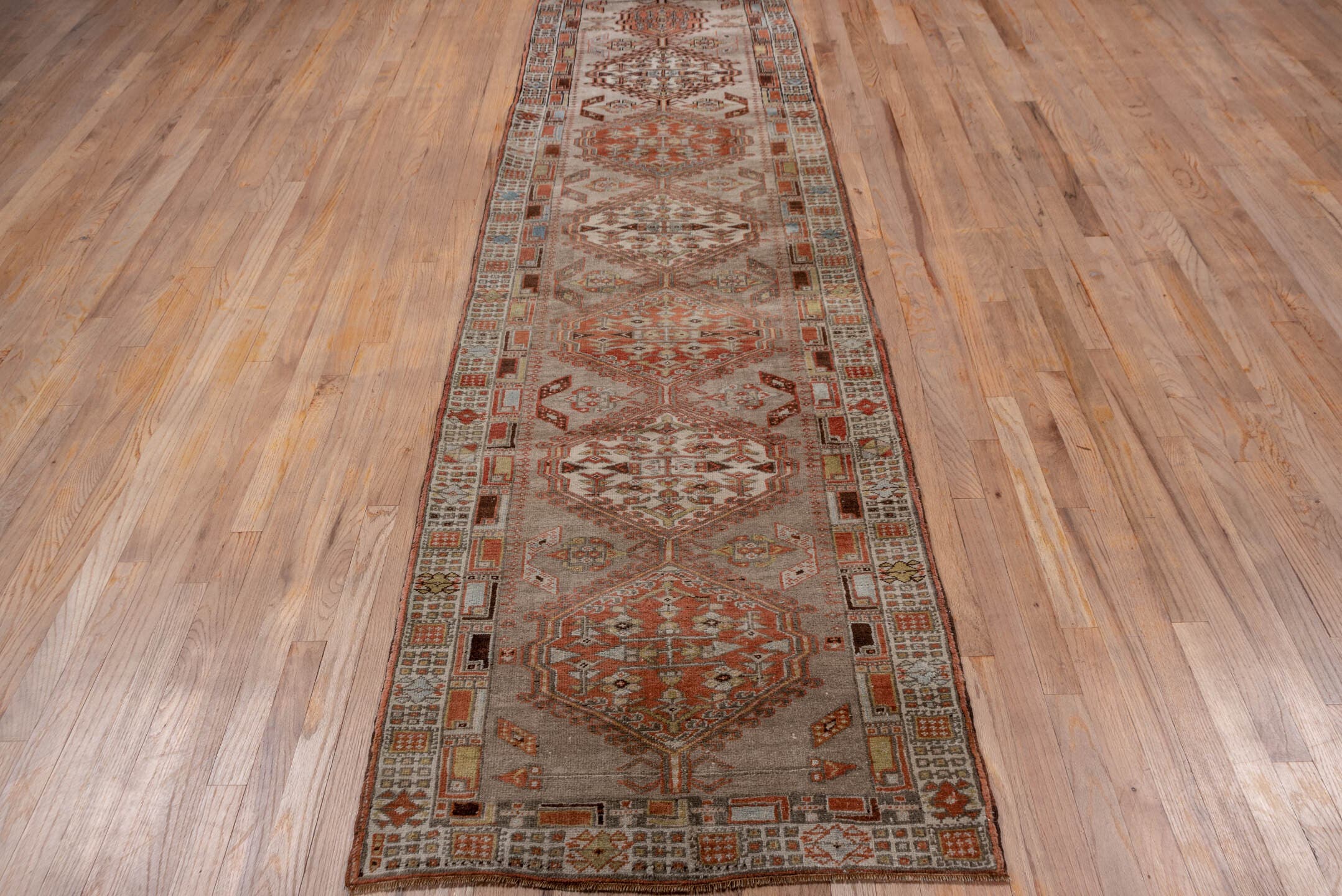 2' x 10' one-of-a-kind handmade antique Sarab runner rug. Color palette: taupe, rust, ivory, brown, pale blue, camel, beige